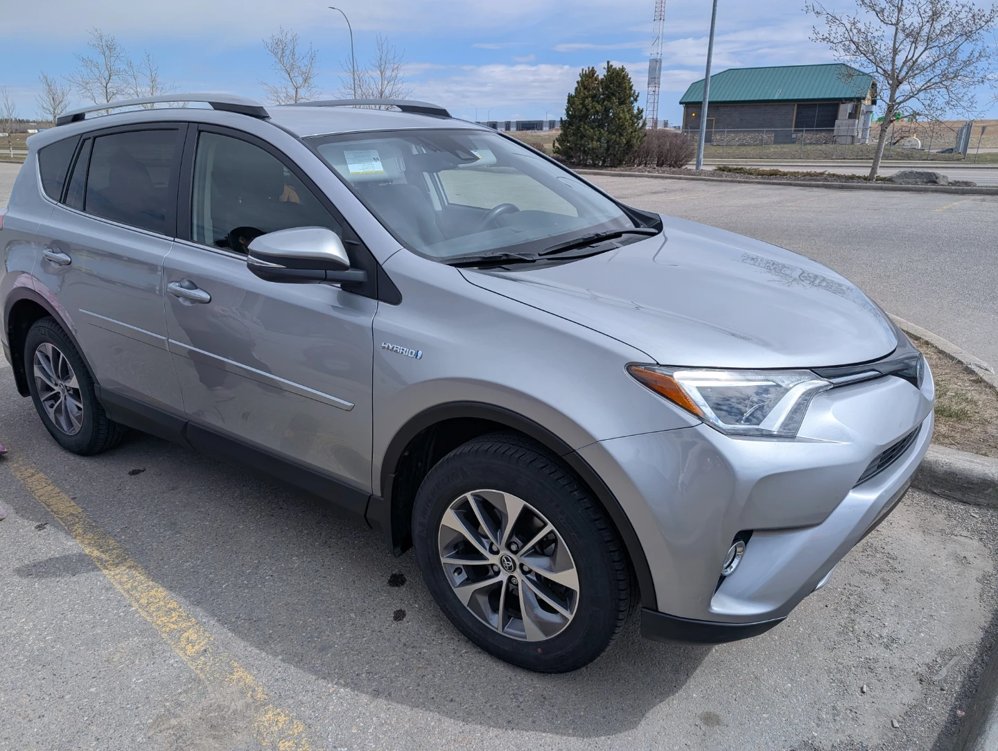 Silver Toyota RAV4 LE Hybrid SUV - photo 2