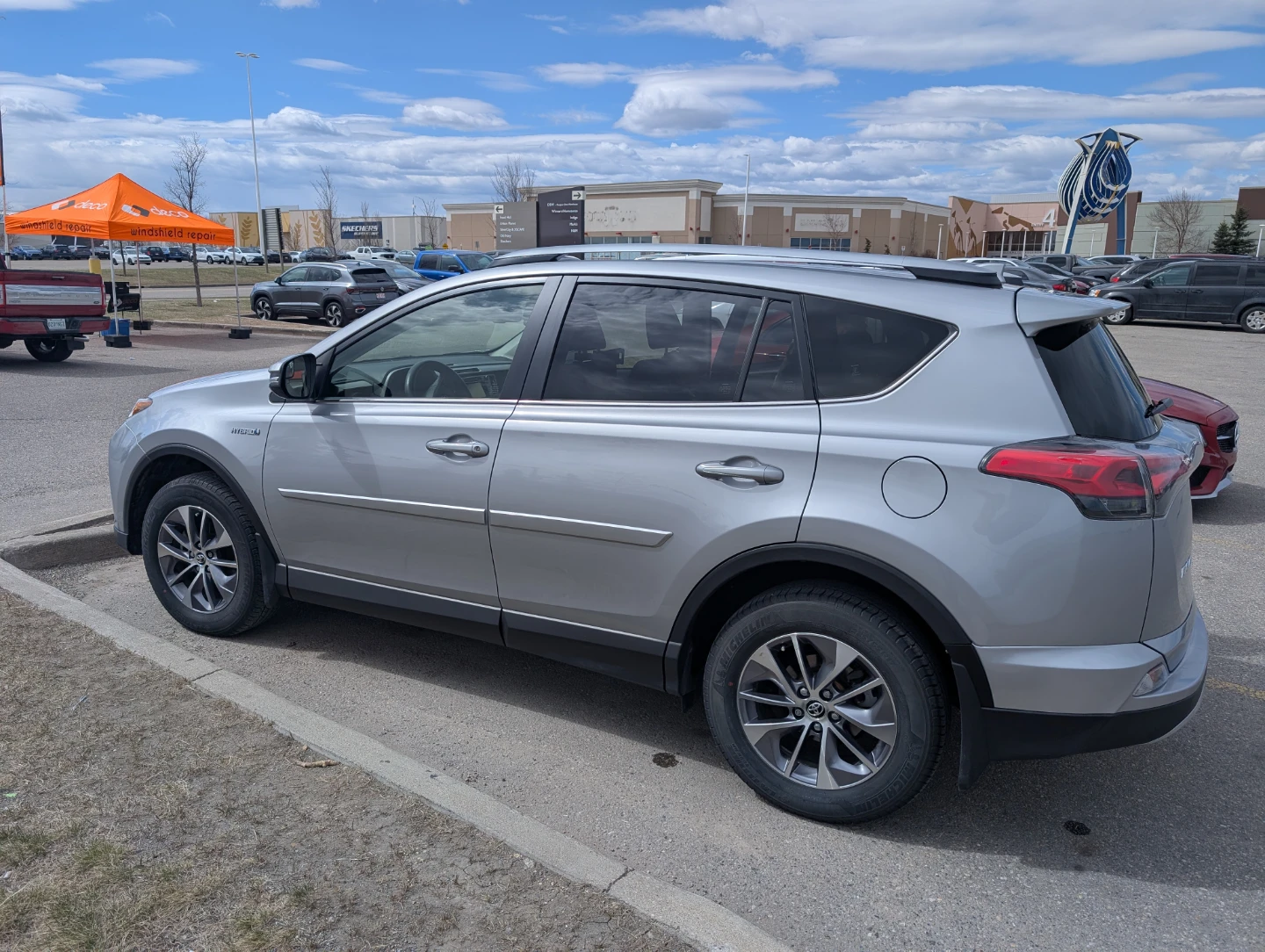 Silver Toyota RAV4 LE Hybrid SUV - photo 3