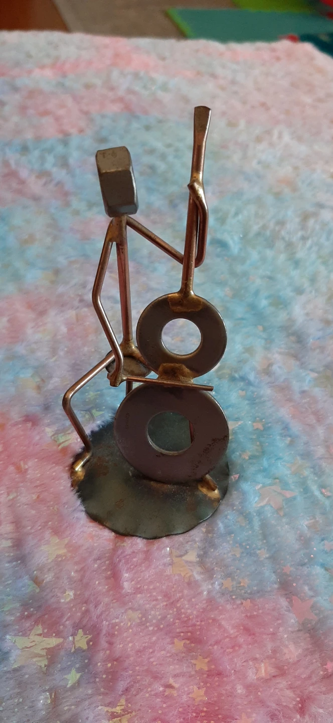 Scrap art figurine sculpture of a cellist