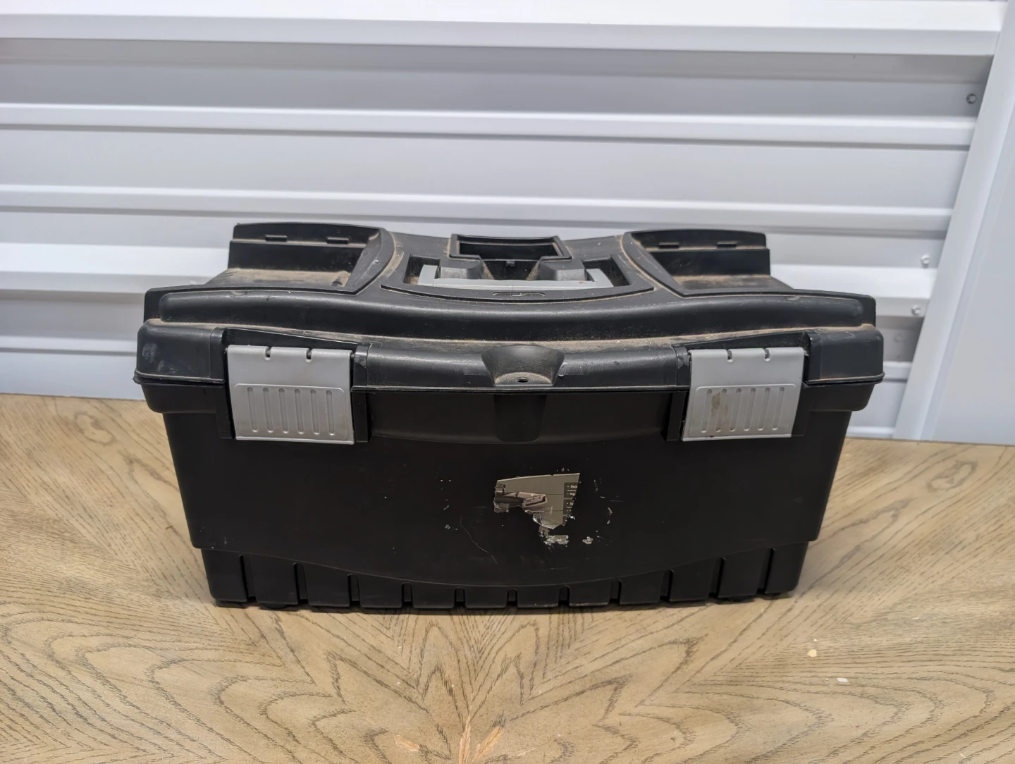 Black Plastic Toolbox with Assorted Tools
