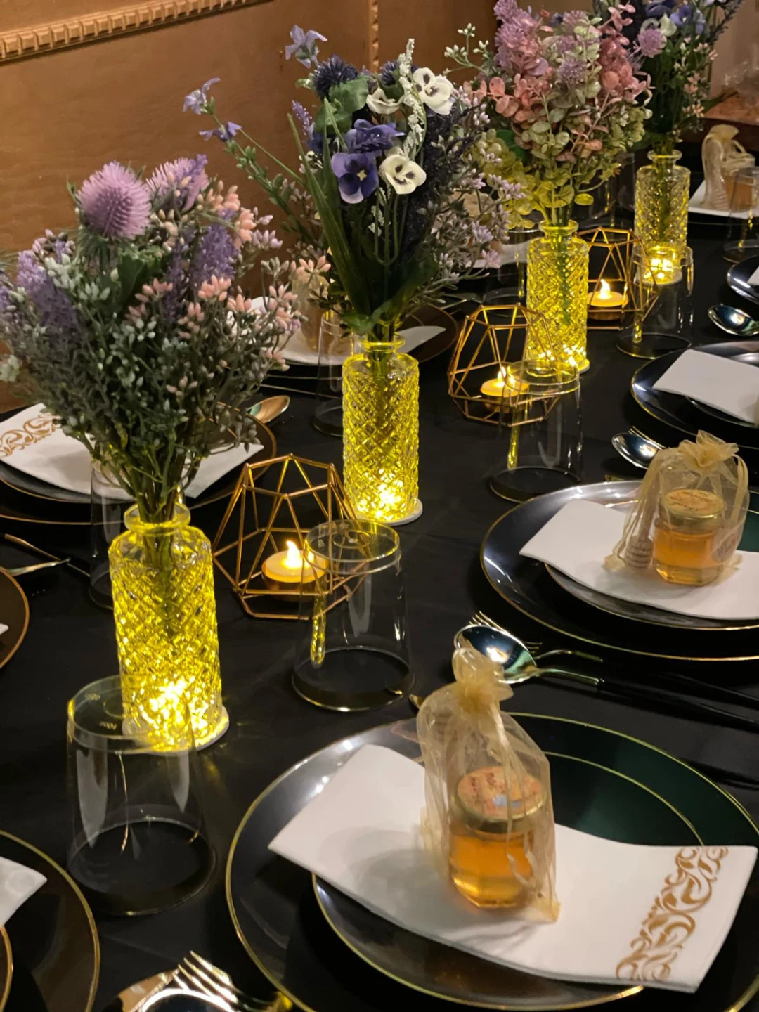 18 Bud vases with colorful flower arragenment and base lights.