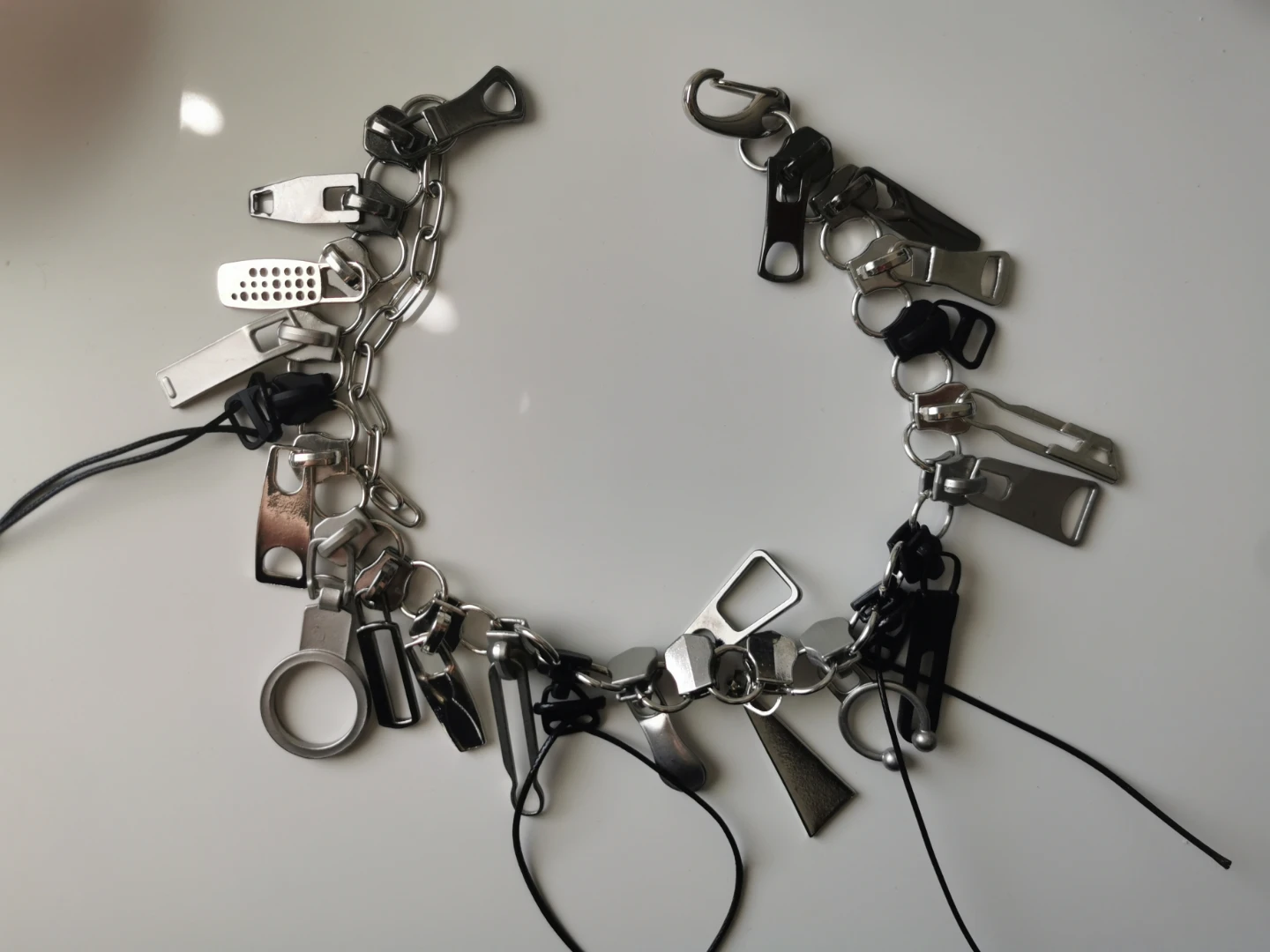 Chain necklace with zipper pulls and charms