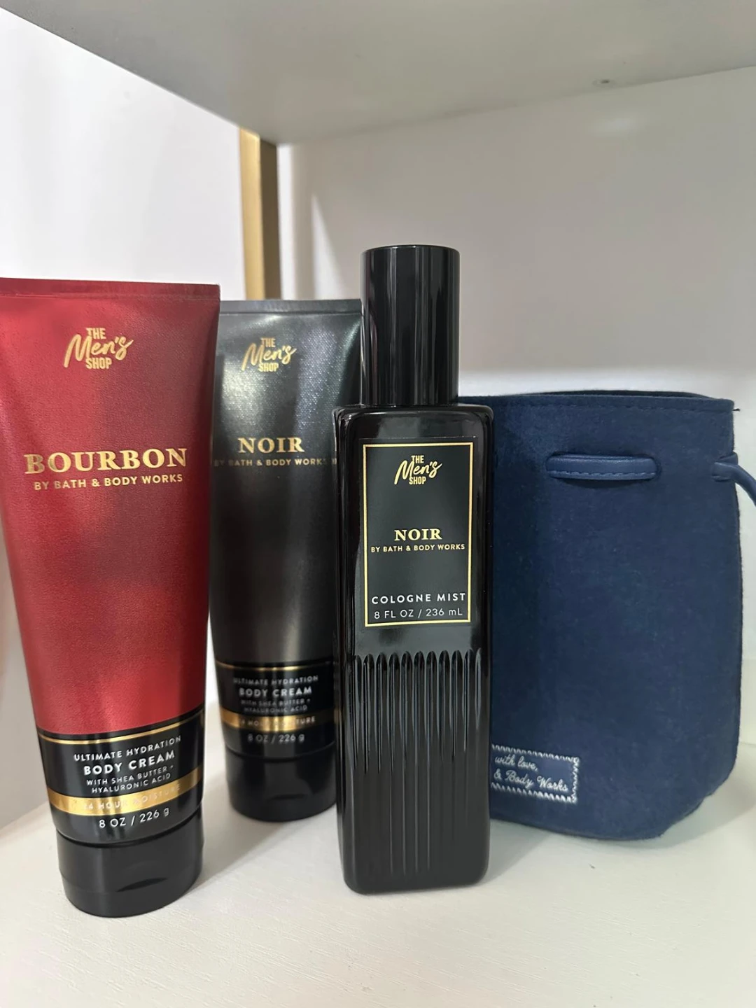 Three Bath & Body Works products plus a bag
