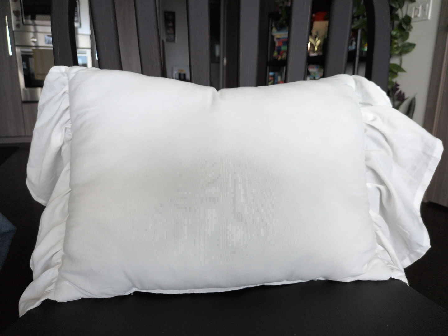 White decorative throw pillow with ruffles
