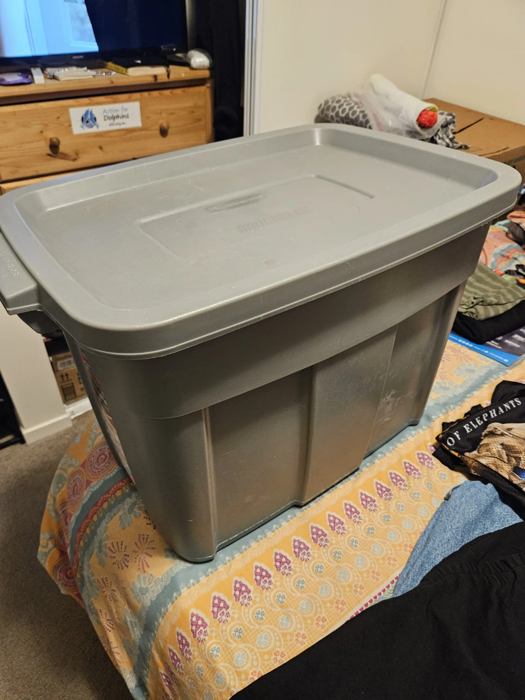 Grey Storage Bin full of assorted clothes