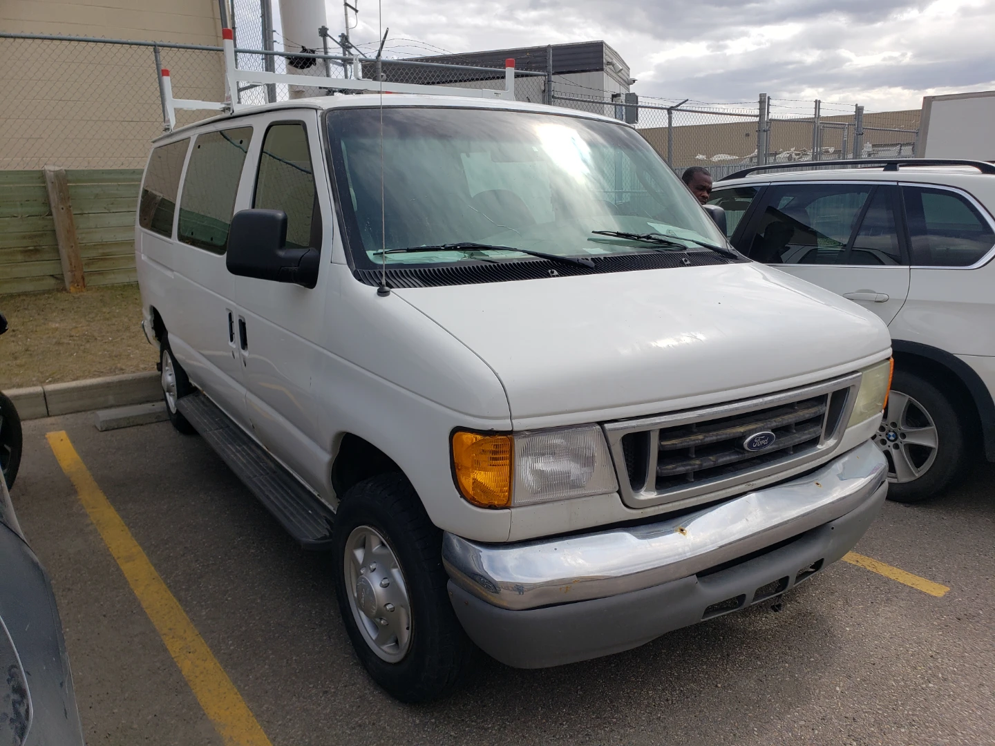 White Ford E-Series Van with Ladder Rack