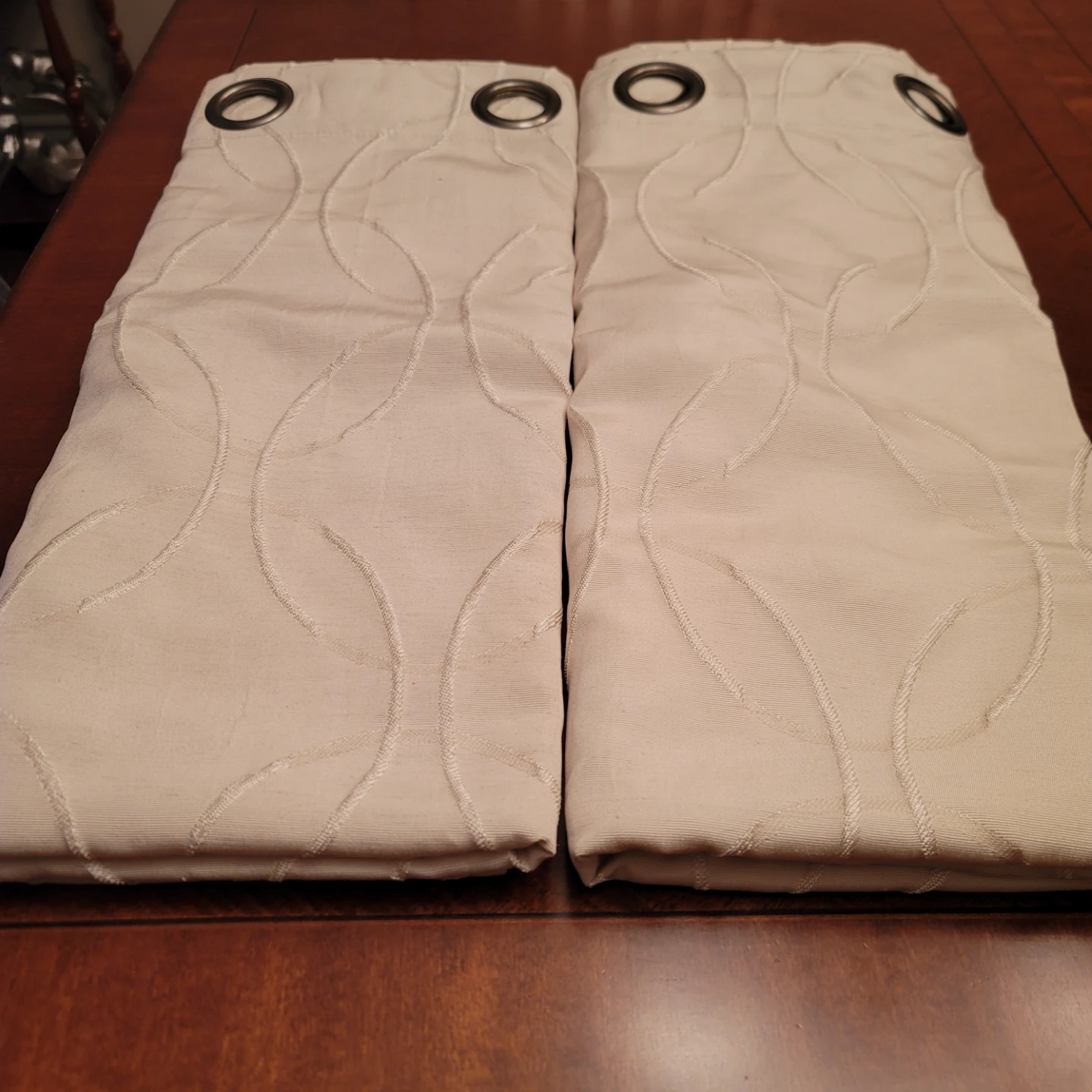 Pair of beige eyelet curtains