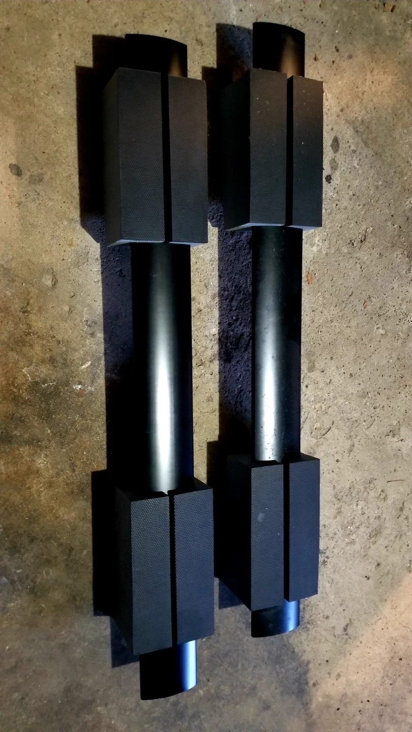 Pair of Black Dumbbells with Textured Grips for car roof