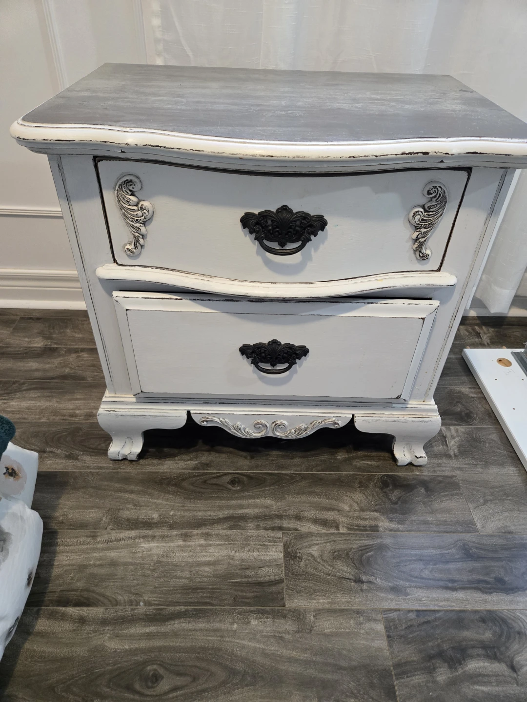 White two-drawer nightstand with decorative hardware