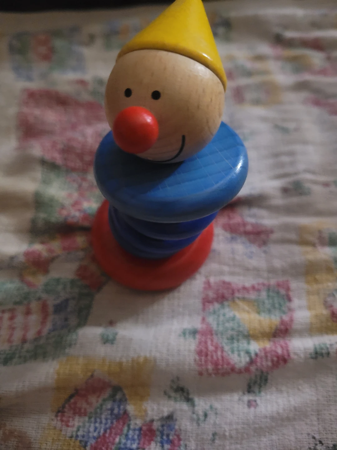 HABA Piro wooden clutching toy and rattle, shaped like a clown.