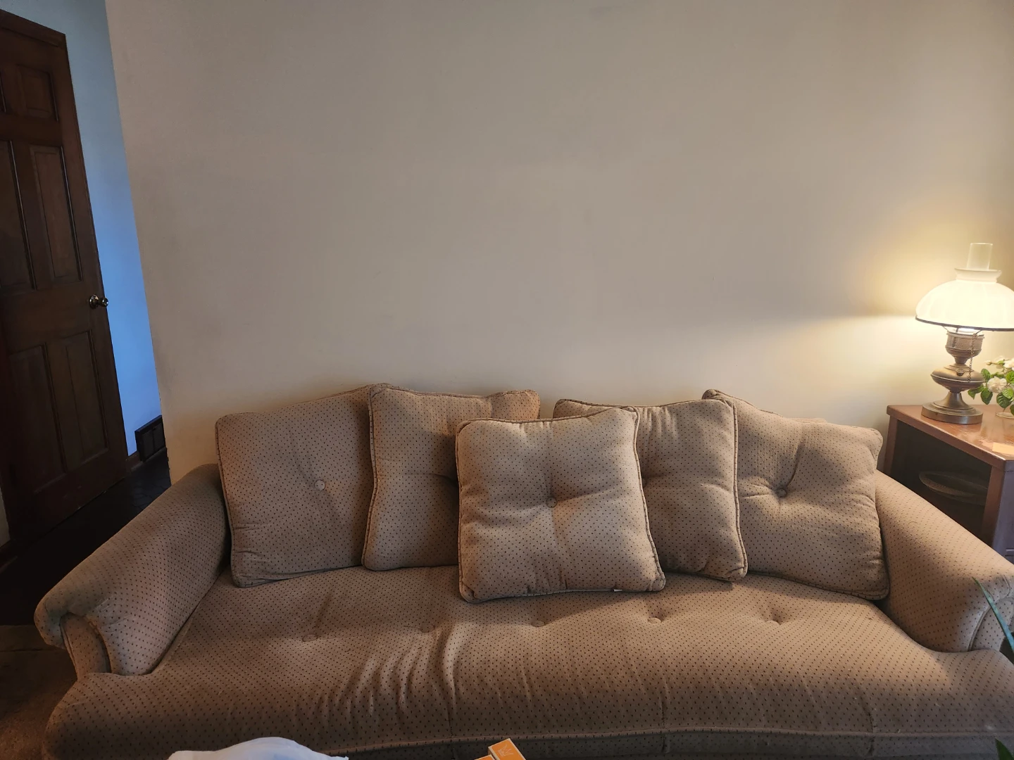Tan Tufted Sofa with Four Cushions