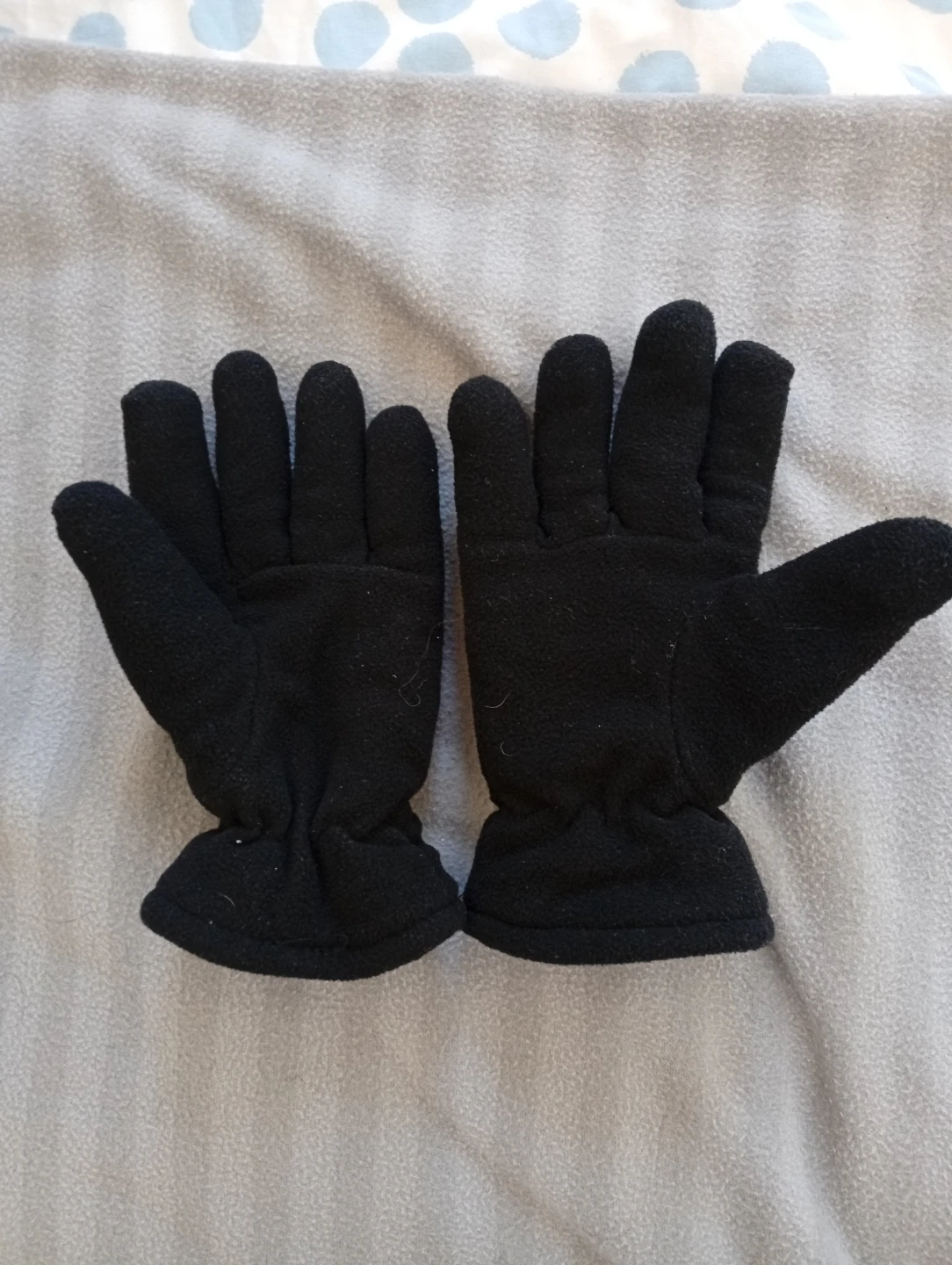 Pair of Beige Knit Gloves and Black Fleece Gloves