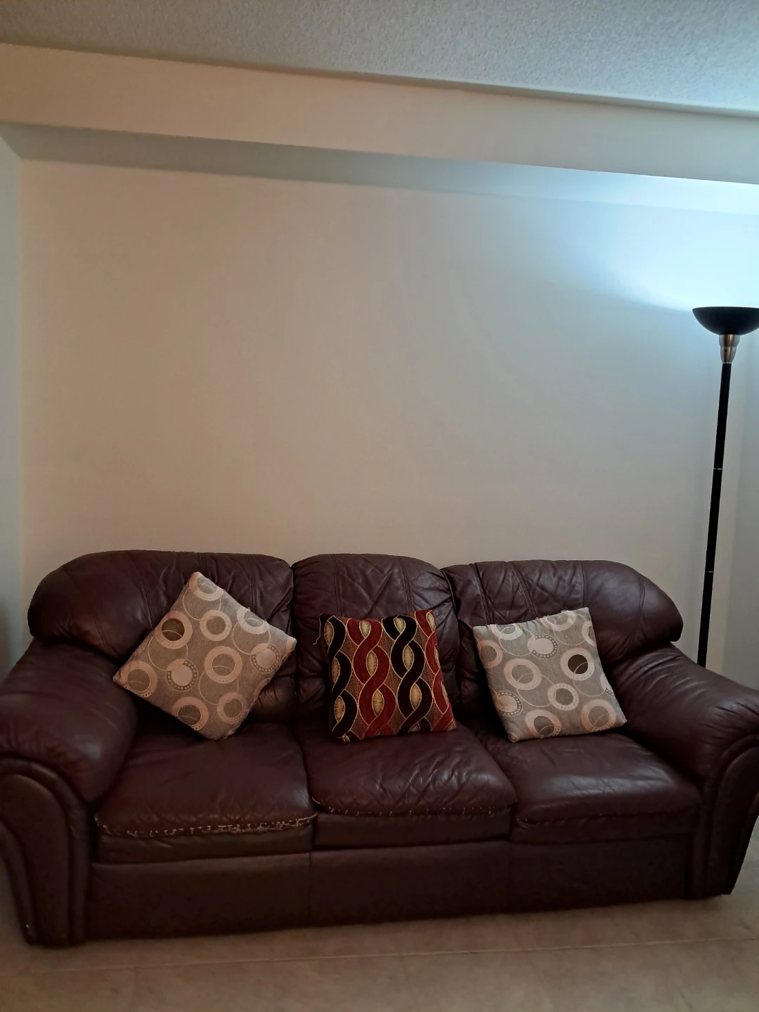 Brown Leather Sofa with Decorative Pillows