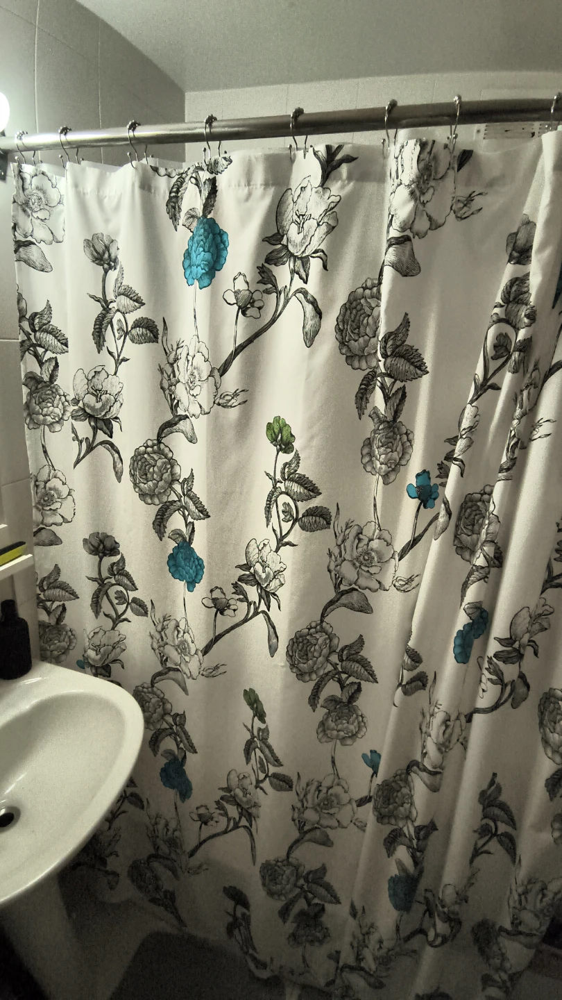 White floral shower curtain and rings