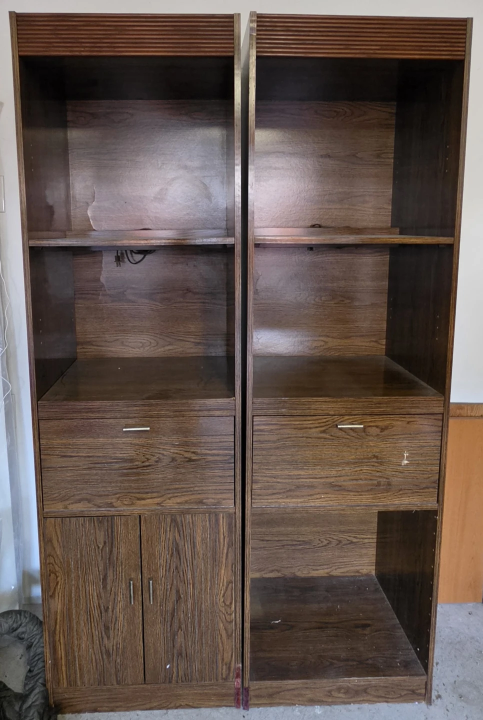 Two-piece wooden bookshelf with cabinets and integrated lighting