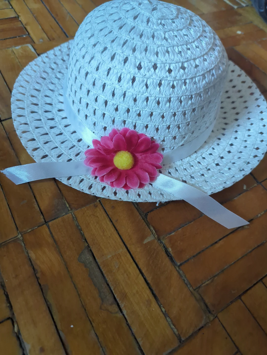 White sun hat with pink flower accent