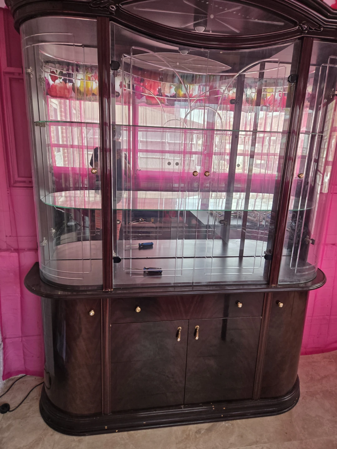 Large glass display cabinet with drawers and doors