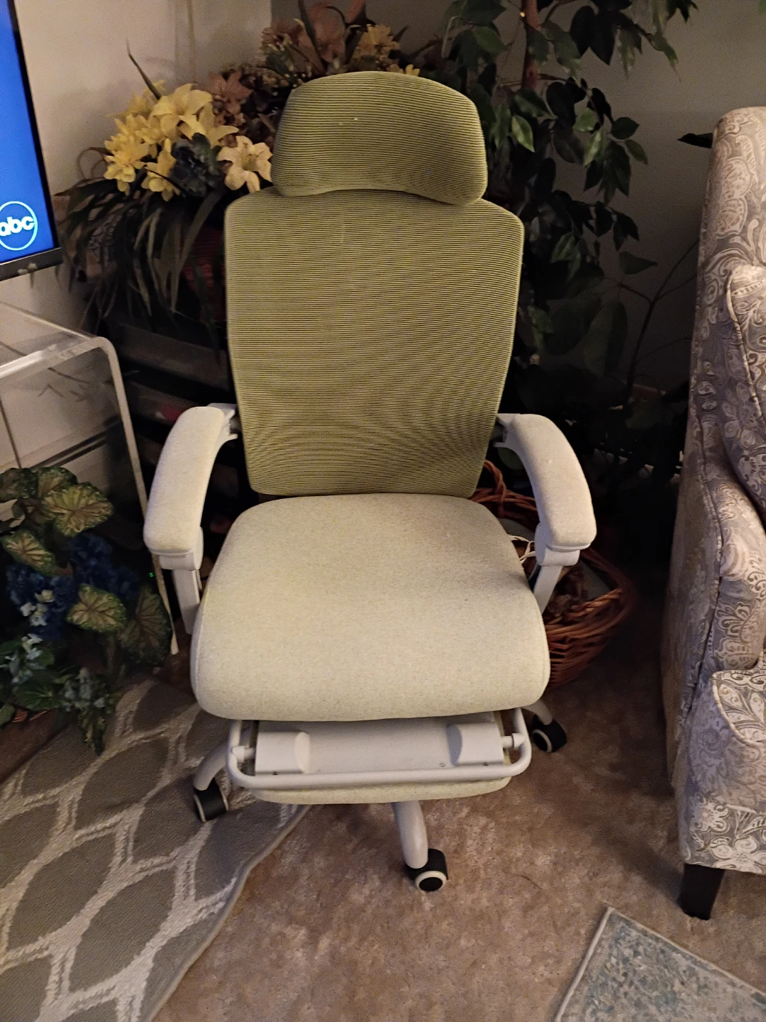 Lime green chair, headrest and footstool, and adjustable height.