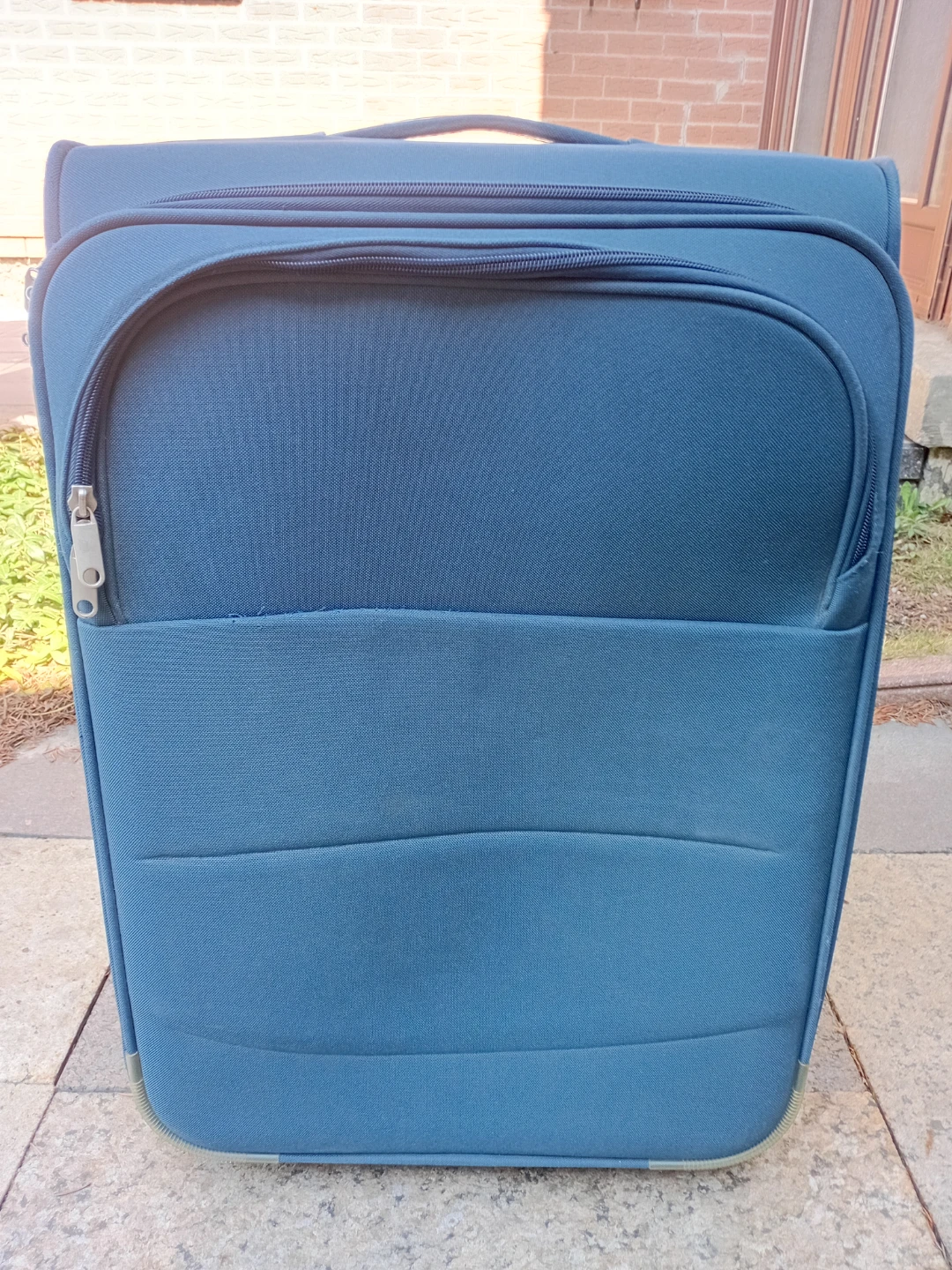 Blue soft-shell rolling suitcase