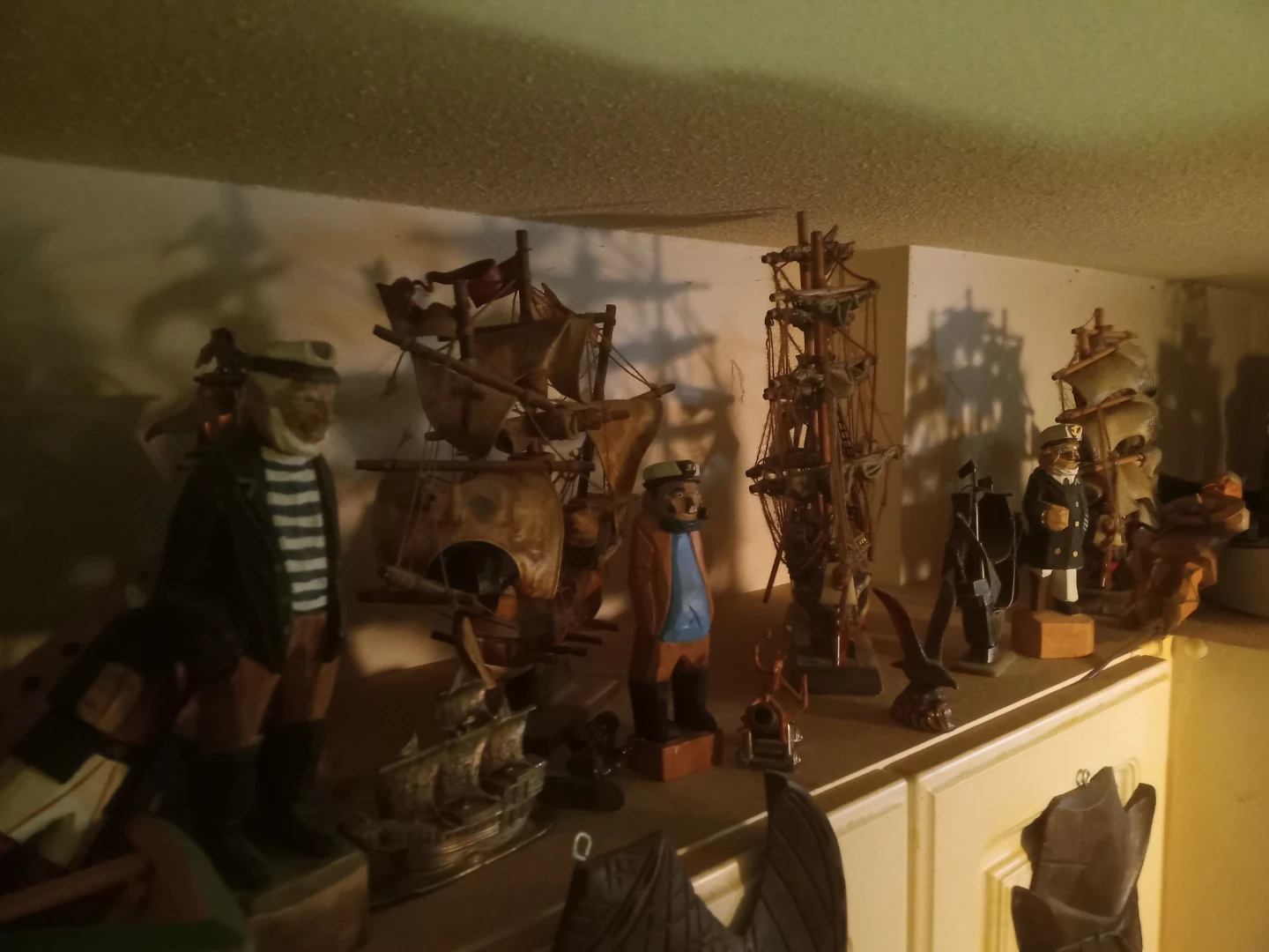 Collection of Wooden Nautical Figurines and Ship Models