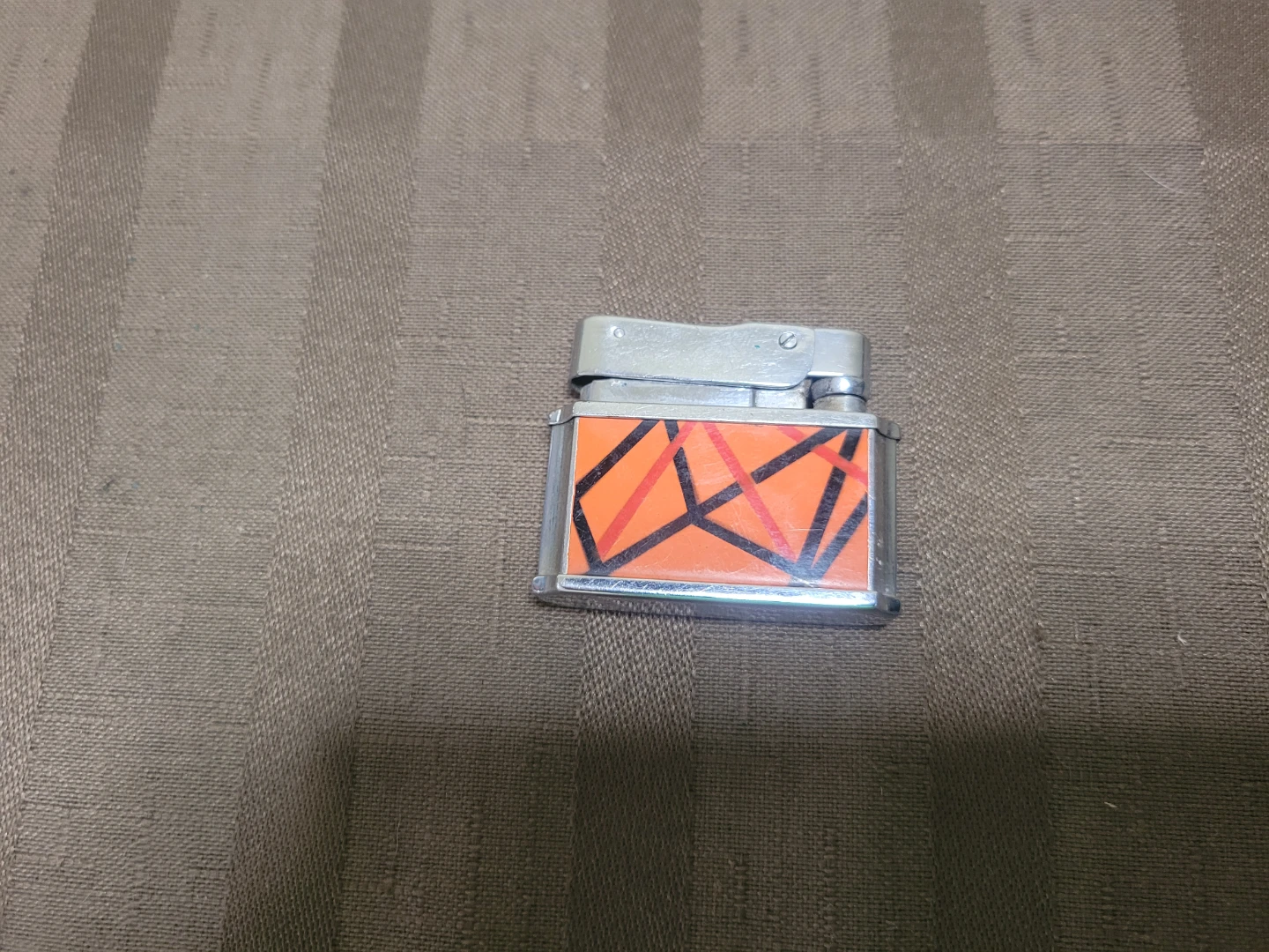 Fisher pocket petrol lighter featuring orange and black lacquer
