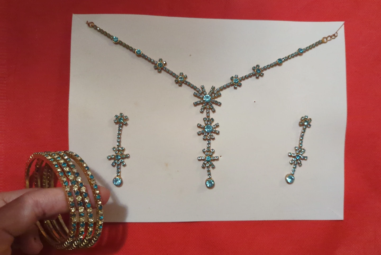 Gold tone blue rhinestone necklace, earrings, and bangles set