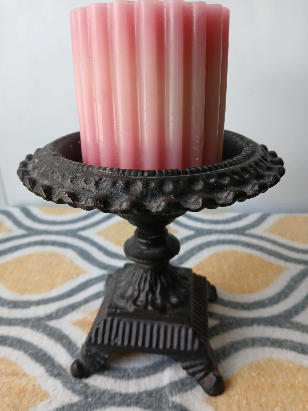 Ornate Cast Iron Candle Holder with Pink Candle. Pick up only.