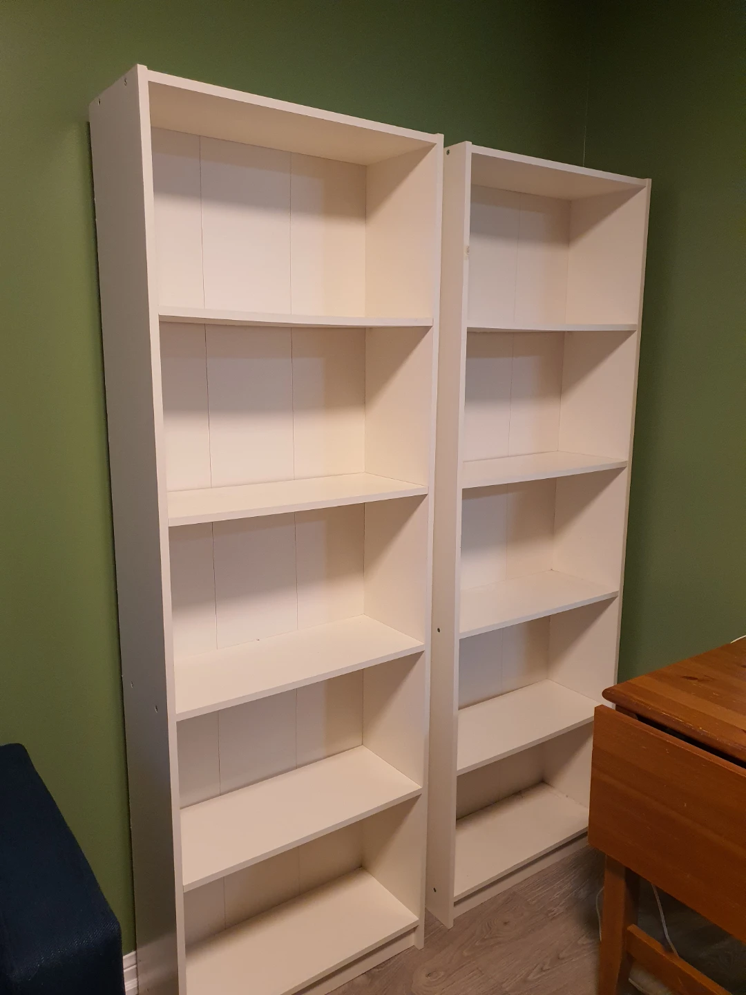 Two IKEA white bookshelves