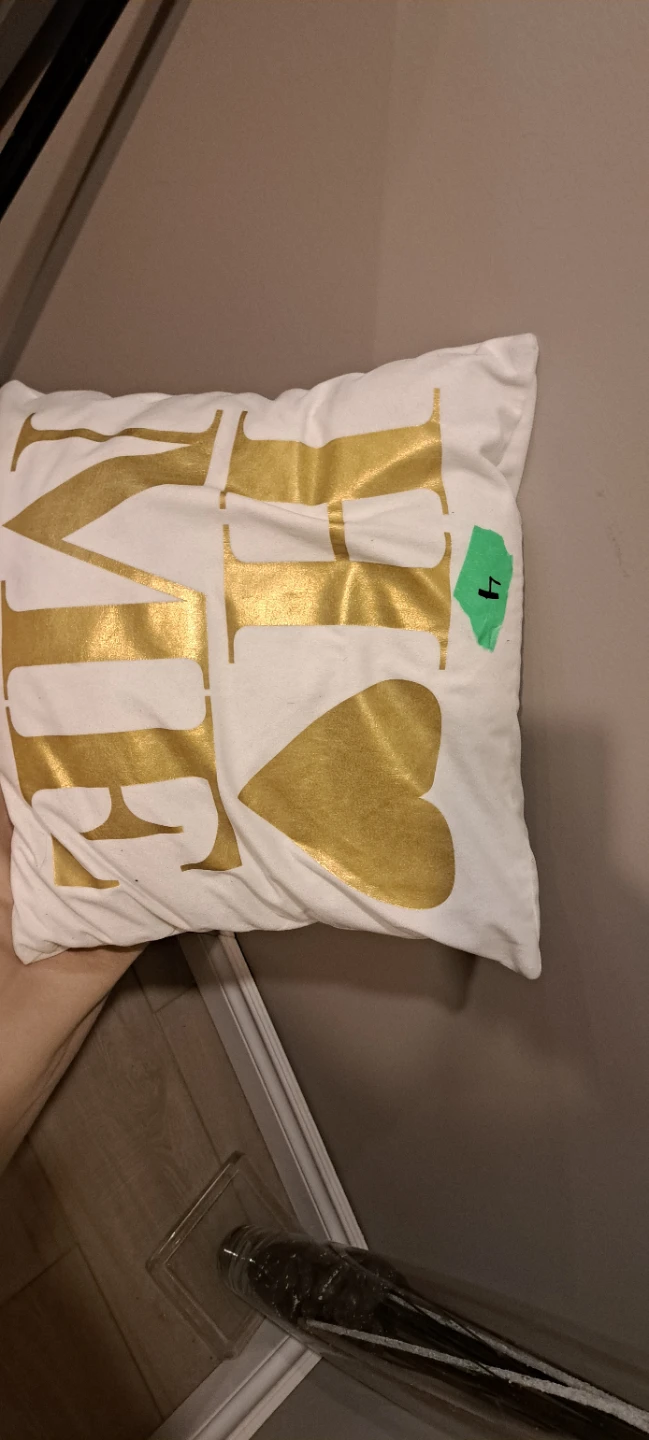 White throw pillow with gold 'LOVE' graphic