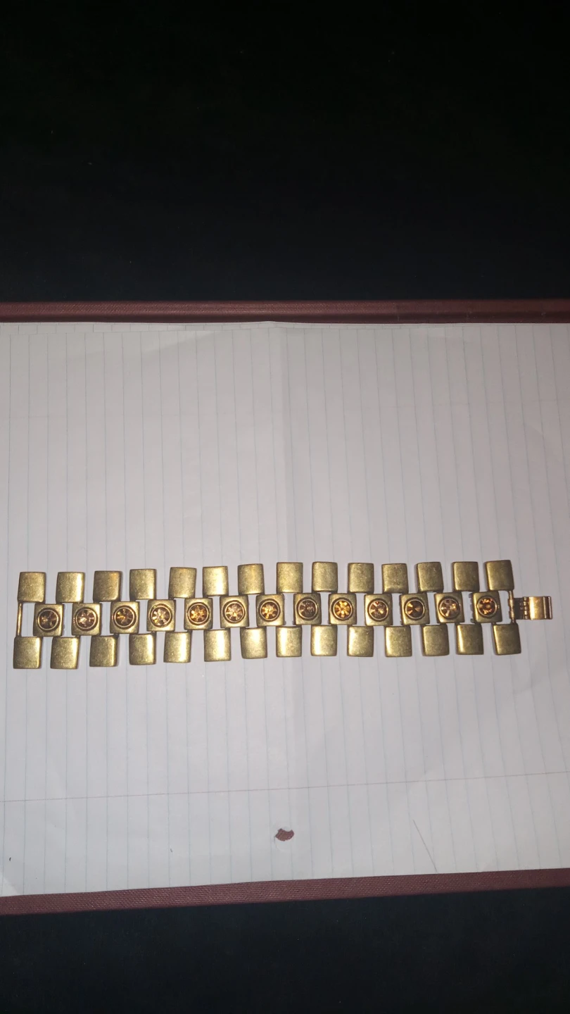 Gold tone link bracelet with ornate center links