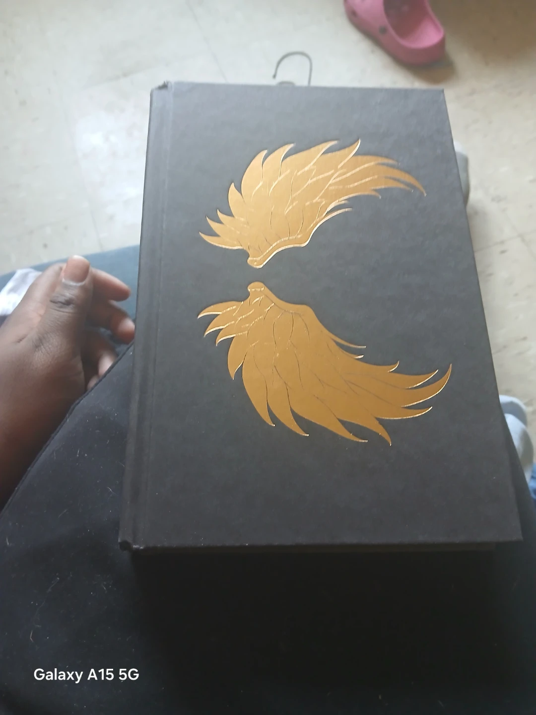 Black Hardcover Book with Gold Wings Design