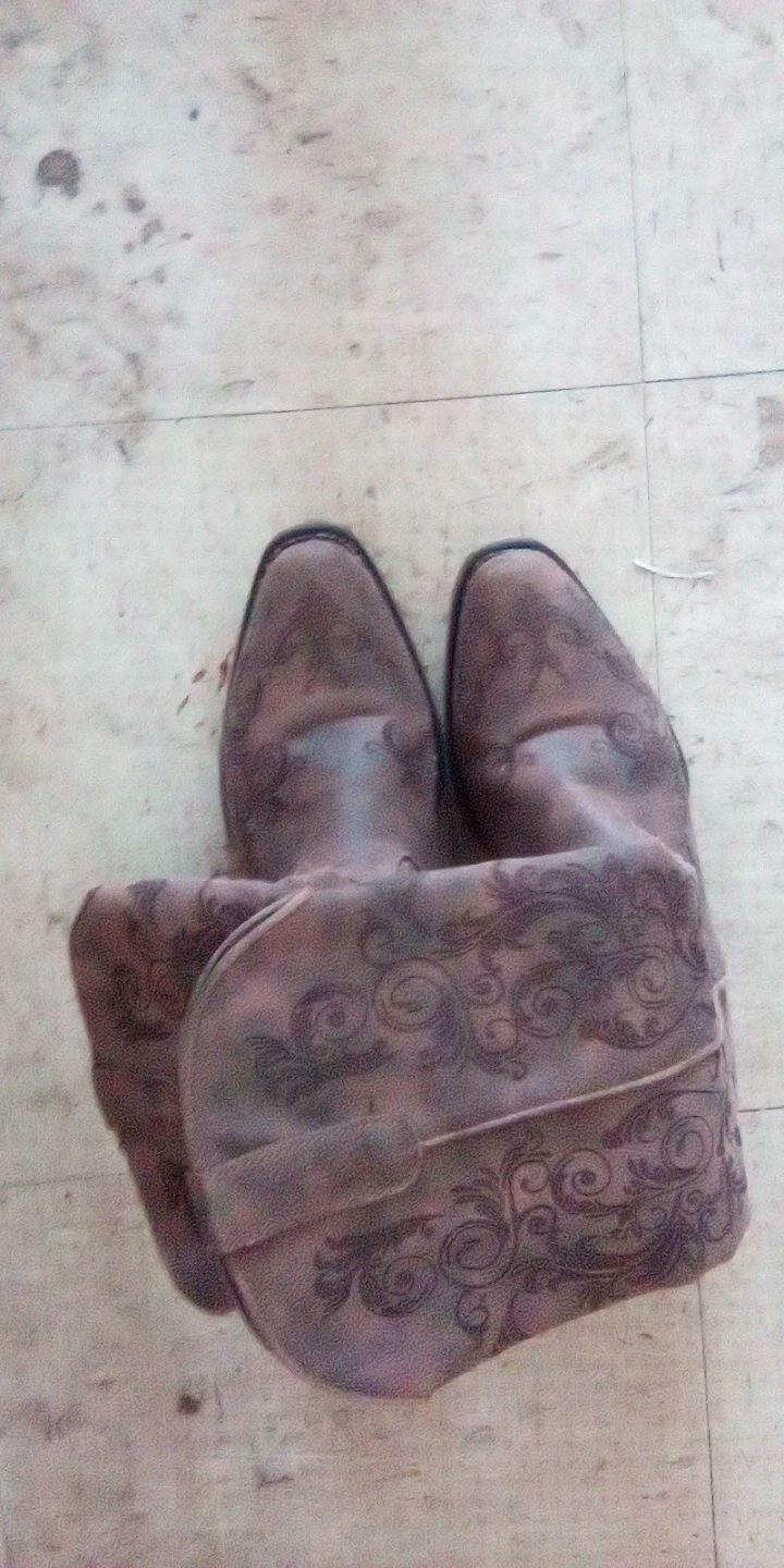 Brown distressed cowboy boots with scroll pattern