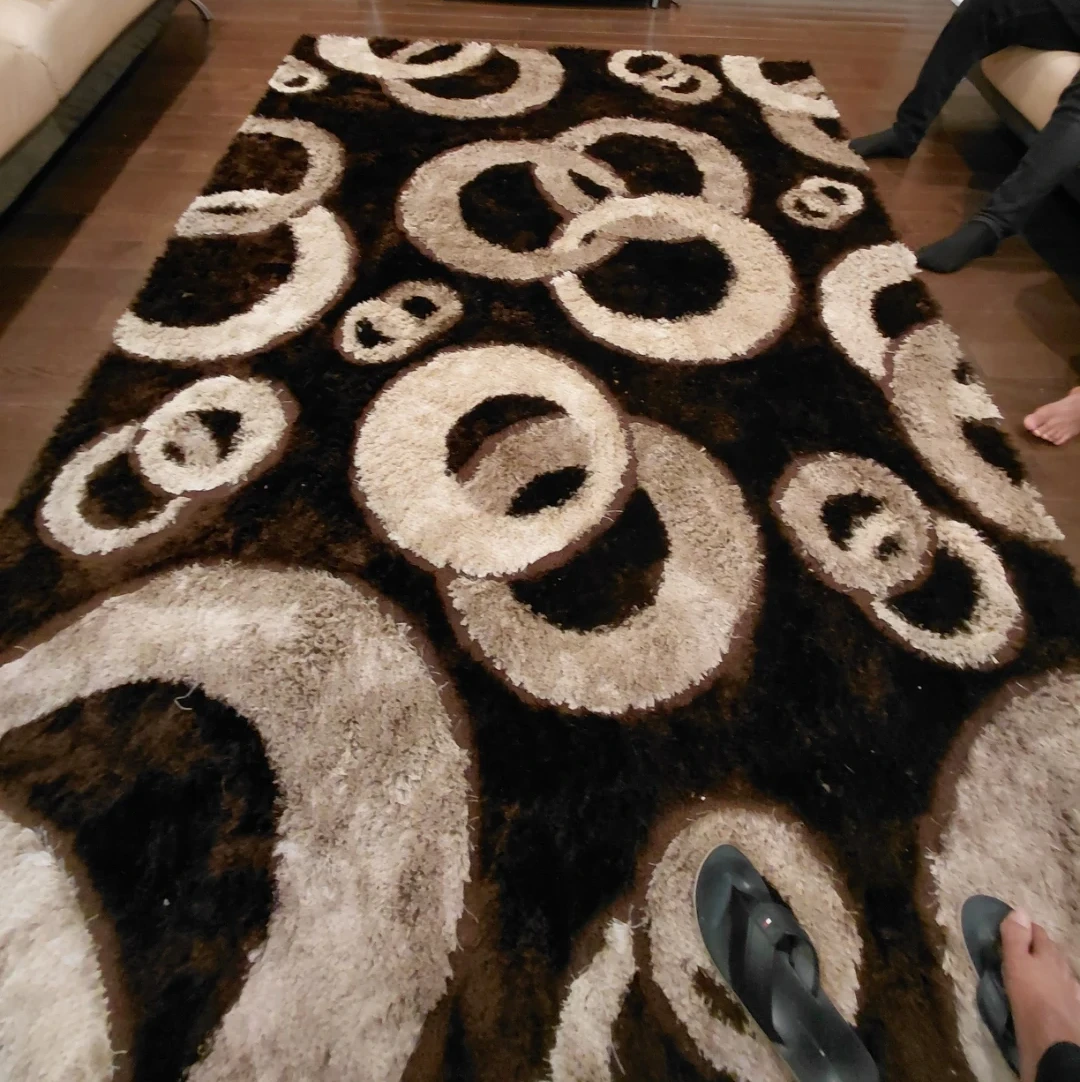 Brown and beige shaggy area rug with circle pattern