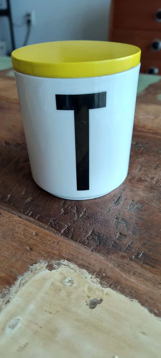 White canister with "T" and yellow lid