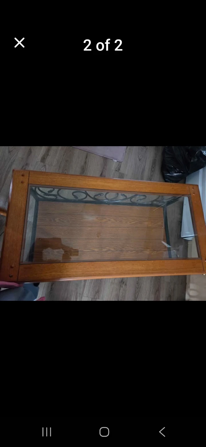 Wooden coffee table with glass top and metal accents