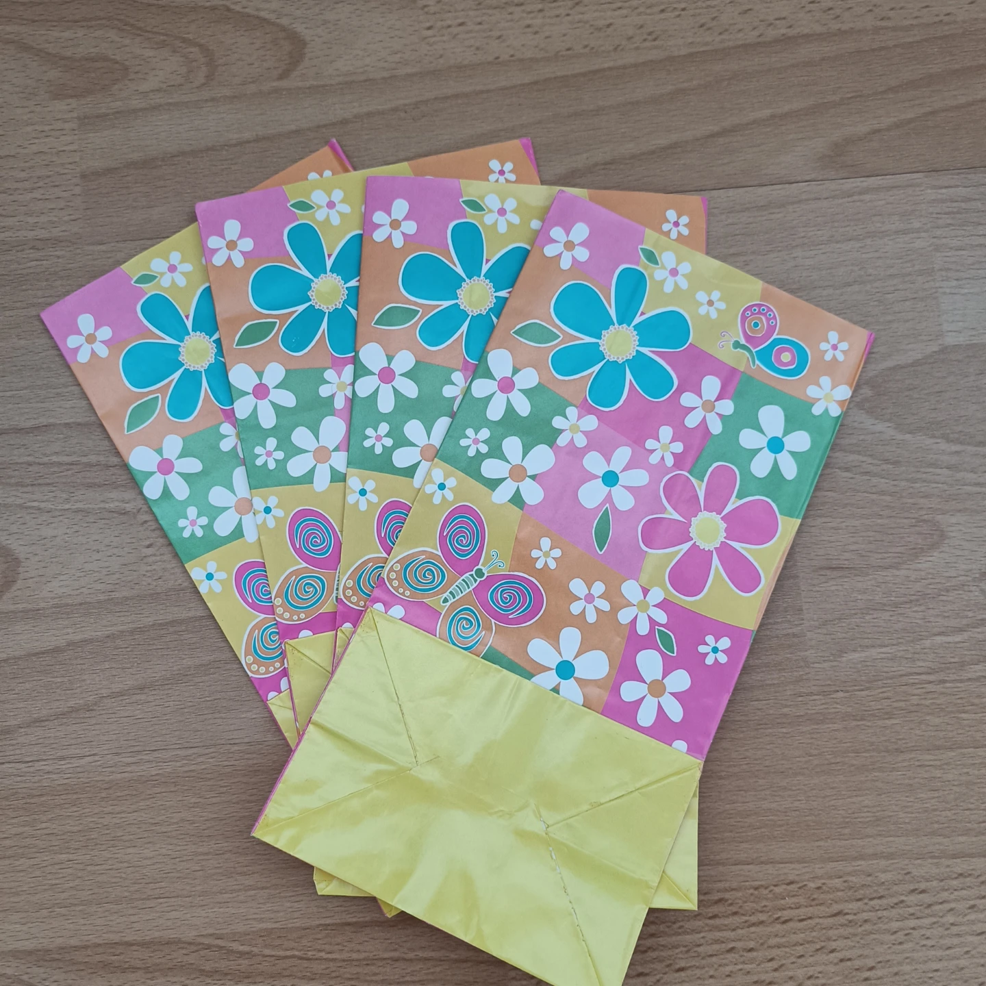Set of 4 colourful gift bags with flowers and butterflies