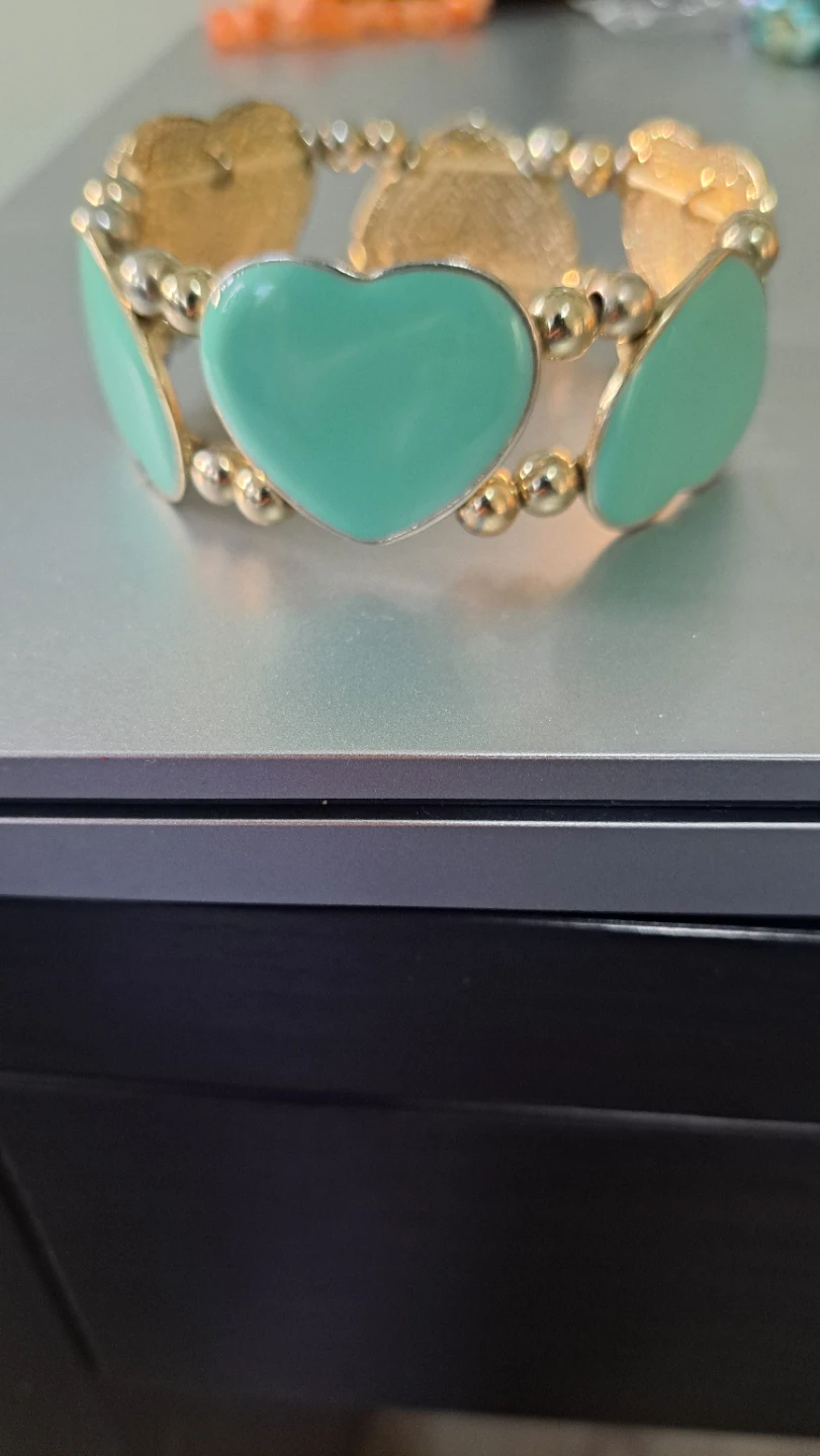 Gold-tone bracelet with mint green heart charms
