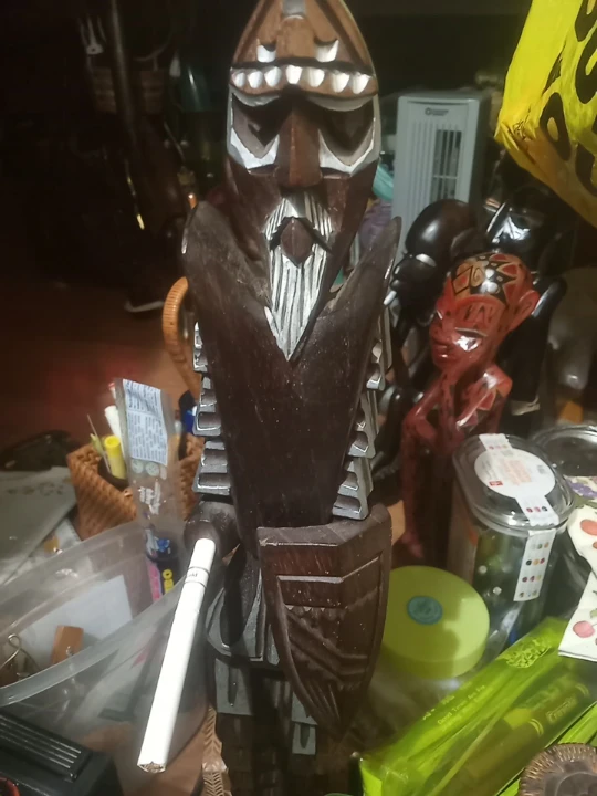 Carved Wooden Figurine with Shield and Sword