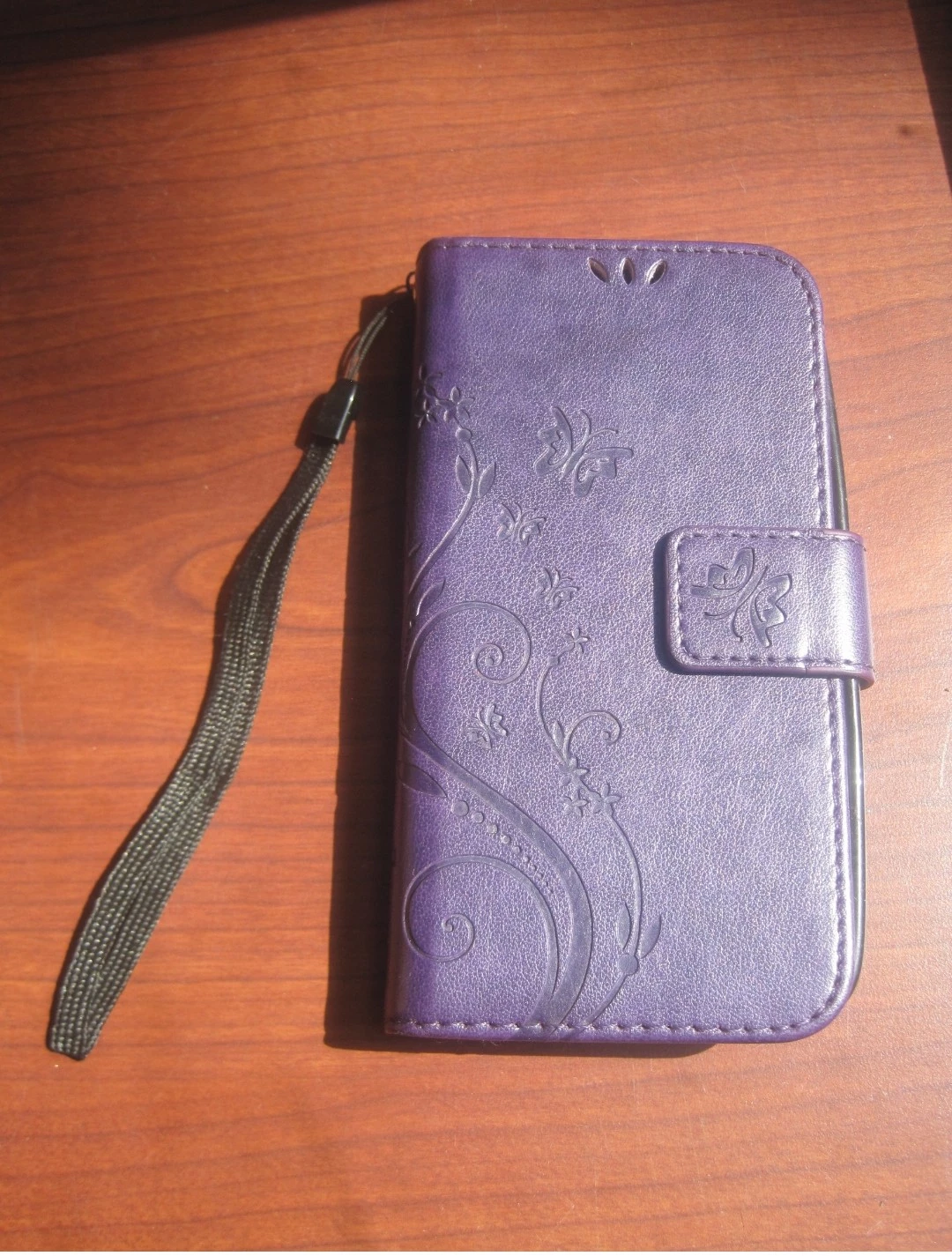Purple Embossed Butterfly Flip Phone Case w/Strap. Pick up only.