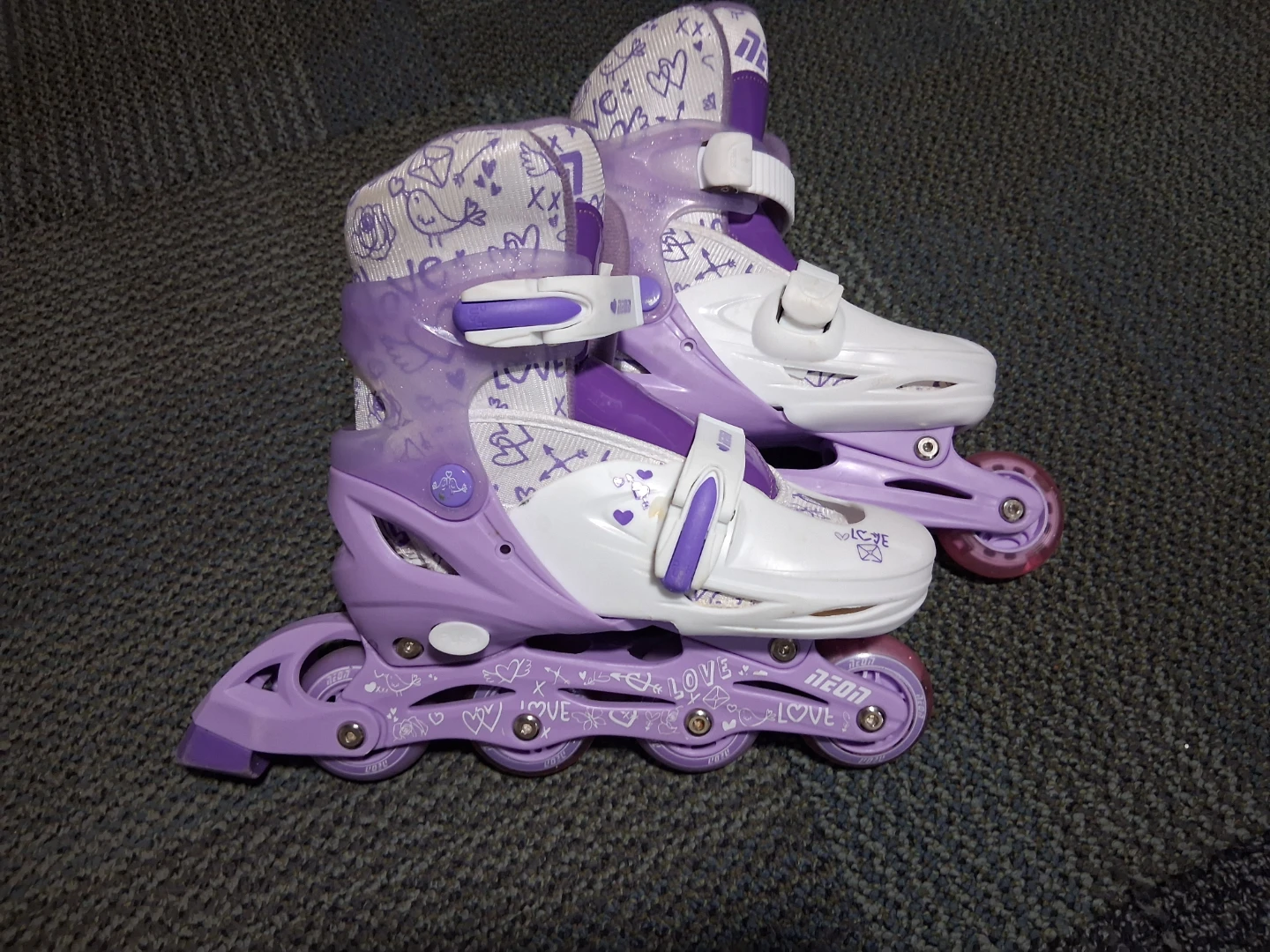 Purple and White Adjustable Inline Skates.