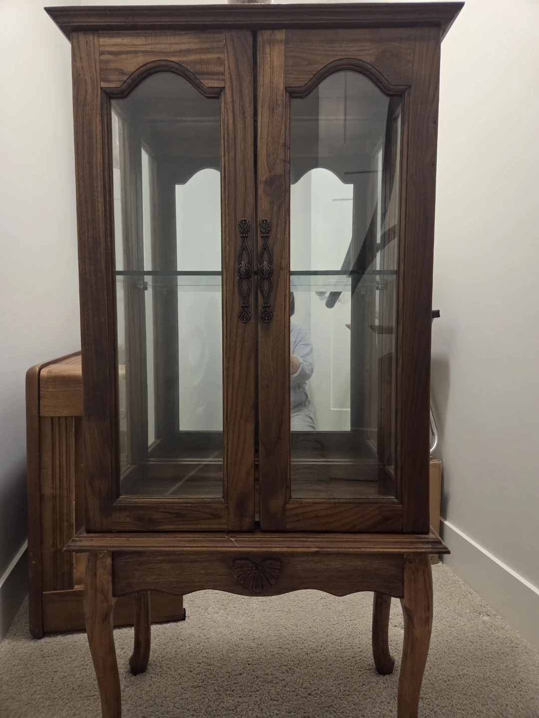 Wooden curio cabinet with glass doors