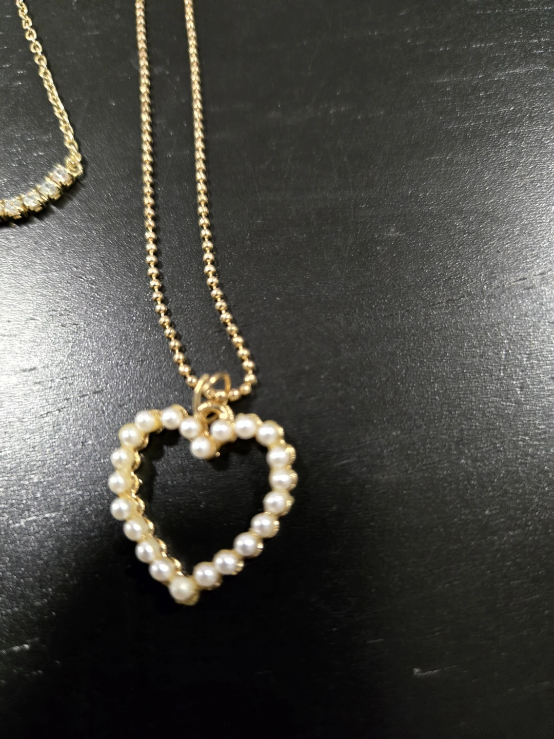 Gold tone necklace with pearl heart pendant