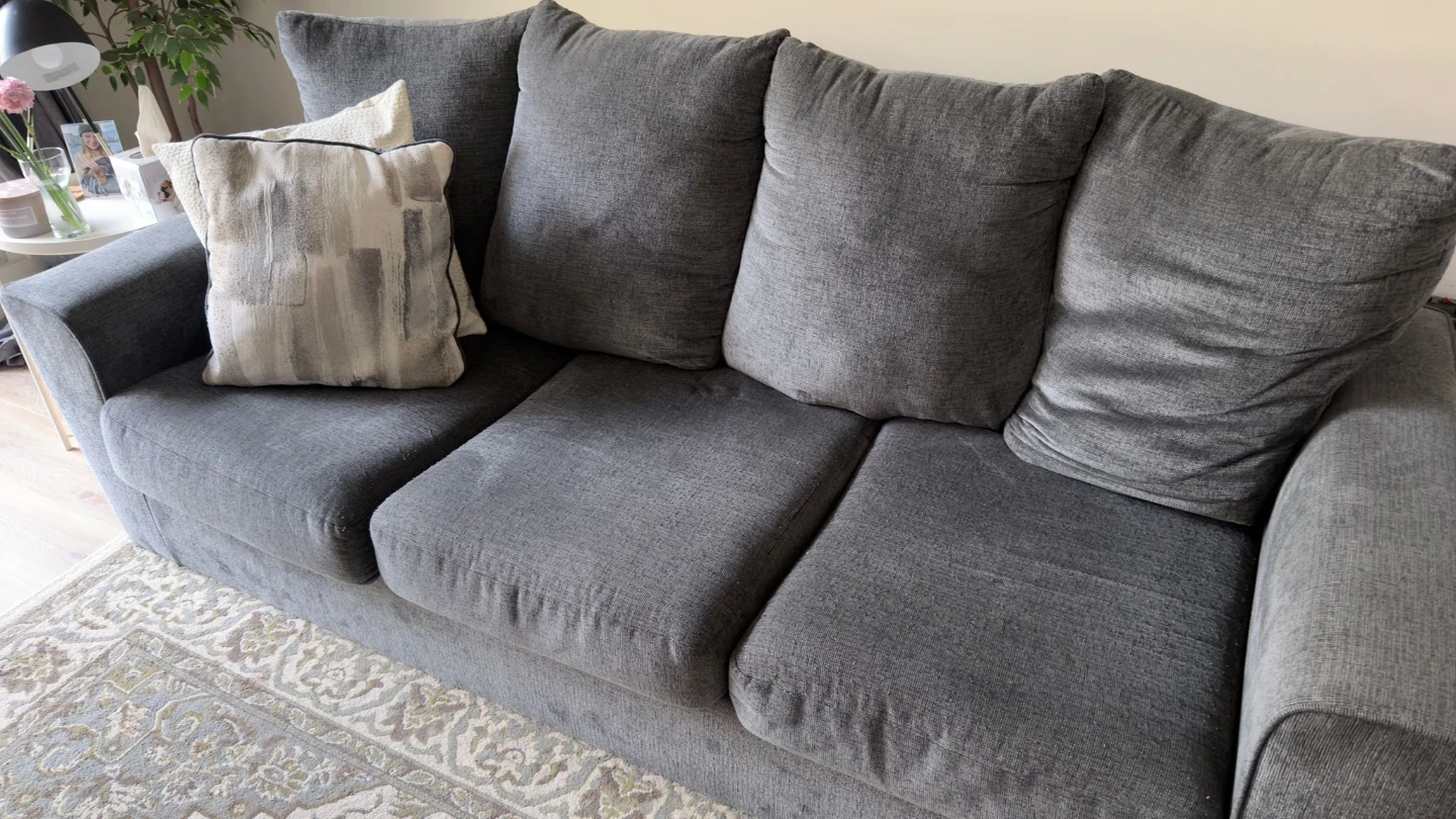 Grey Sofa with Cushions and Throw Blanket