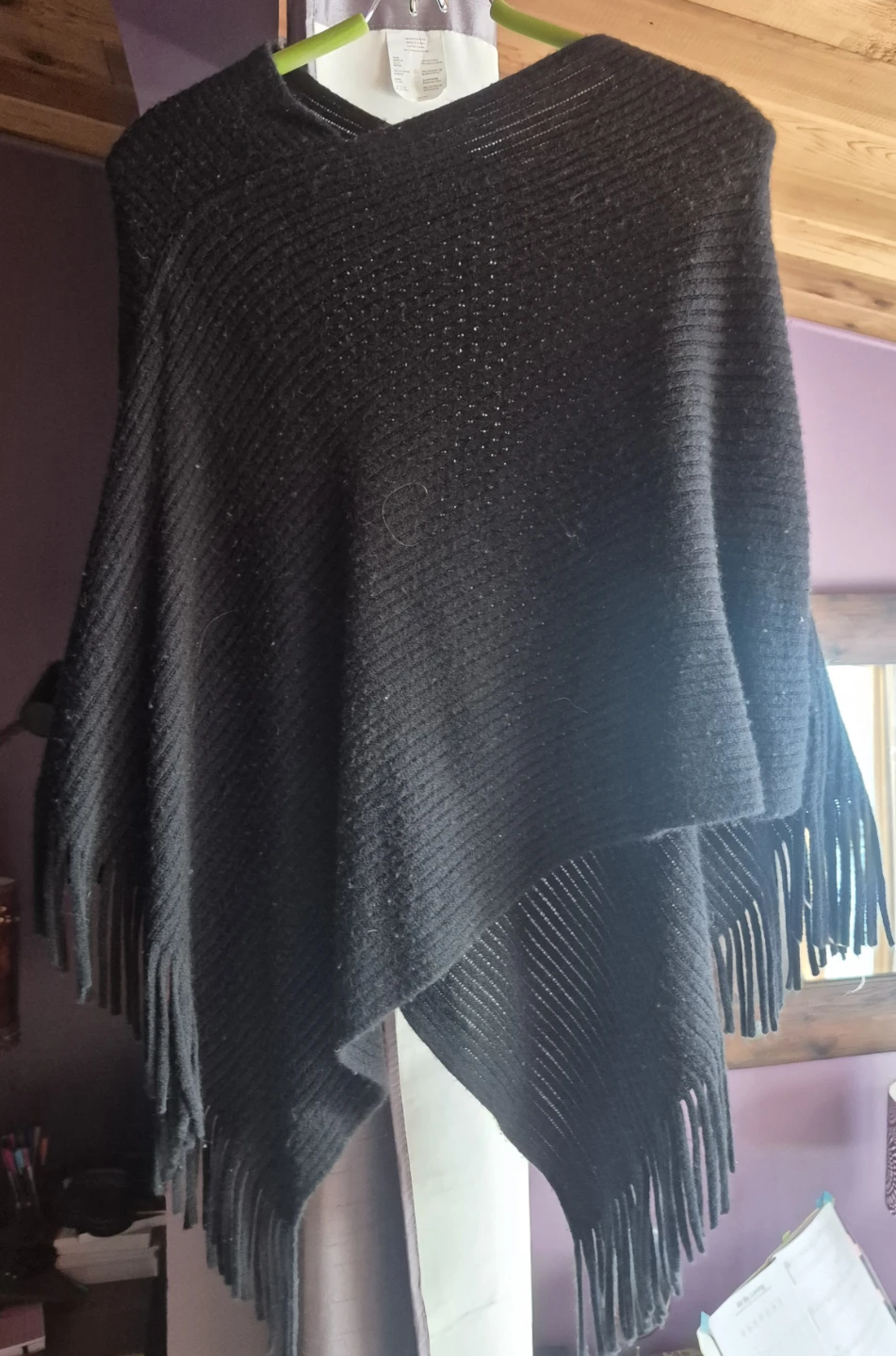 Black knit poncho with fringe