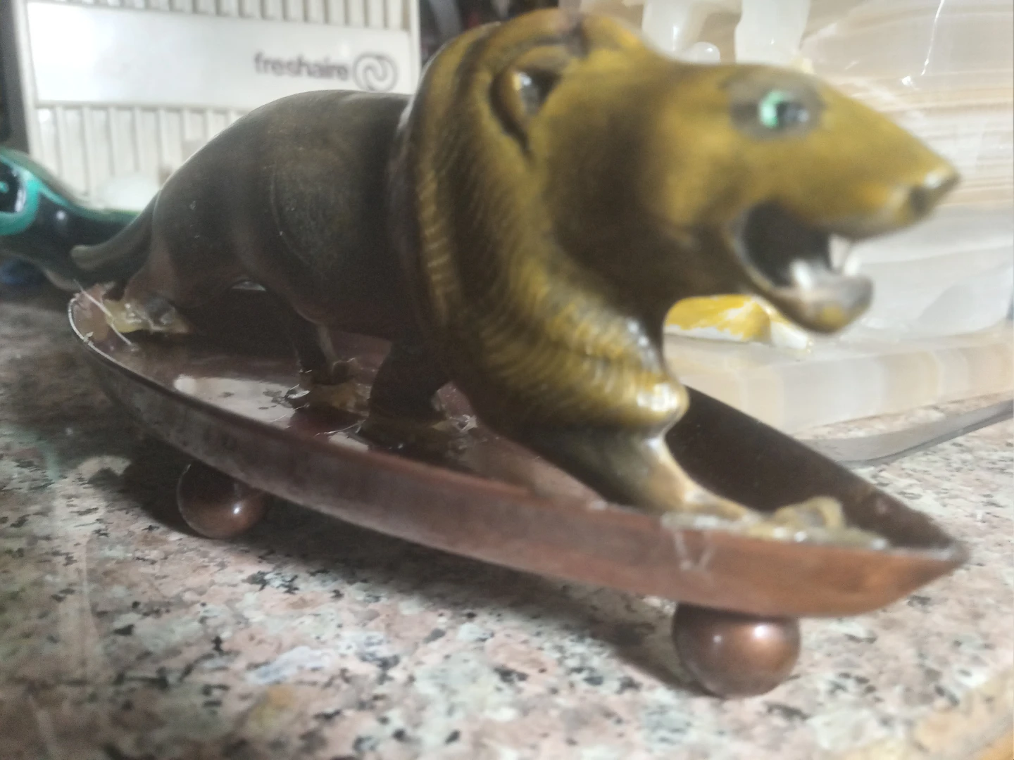 Horn carved lion on copper tray