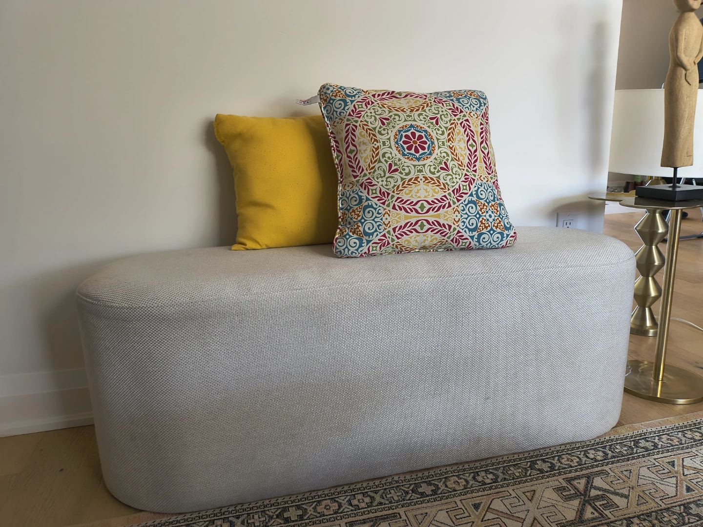 Modern upholstered bench with decorative pillows