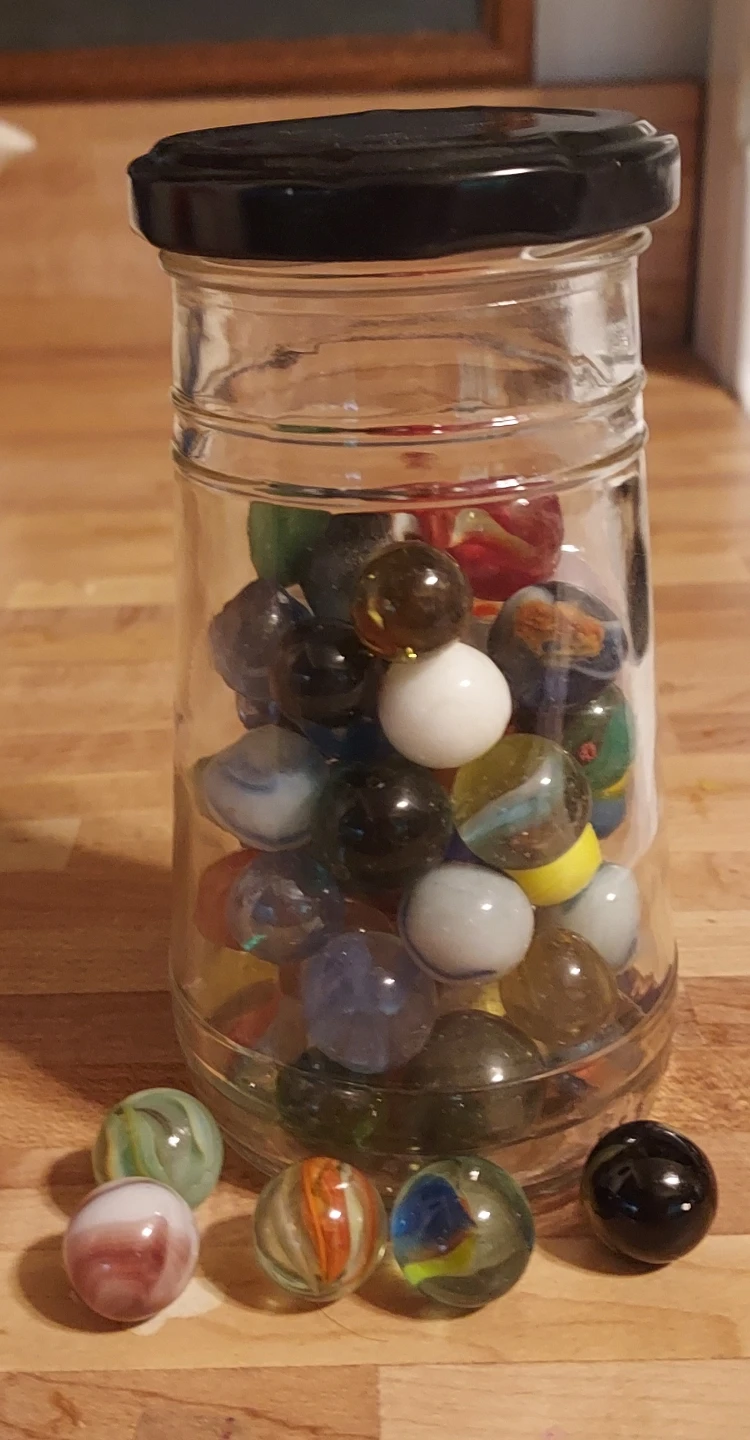 Jar of assorted glass marbles