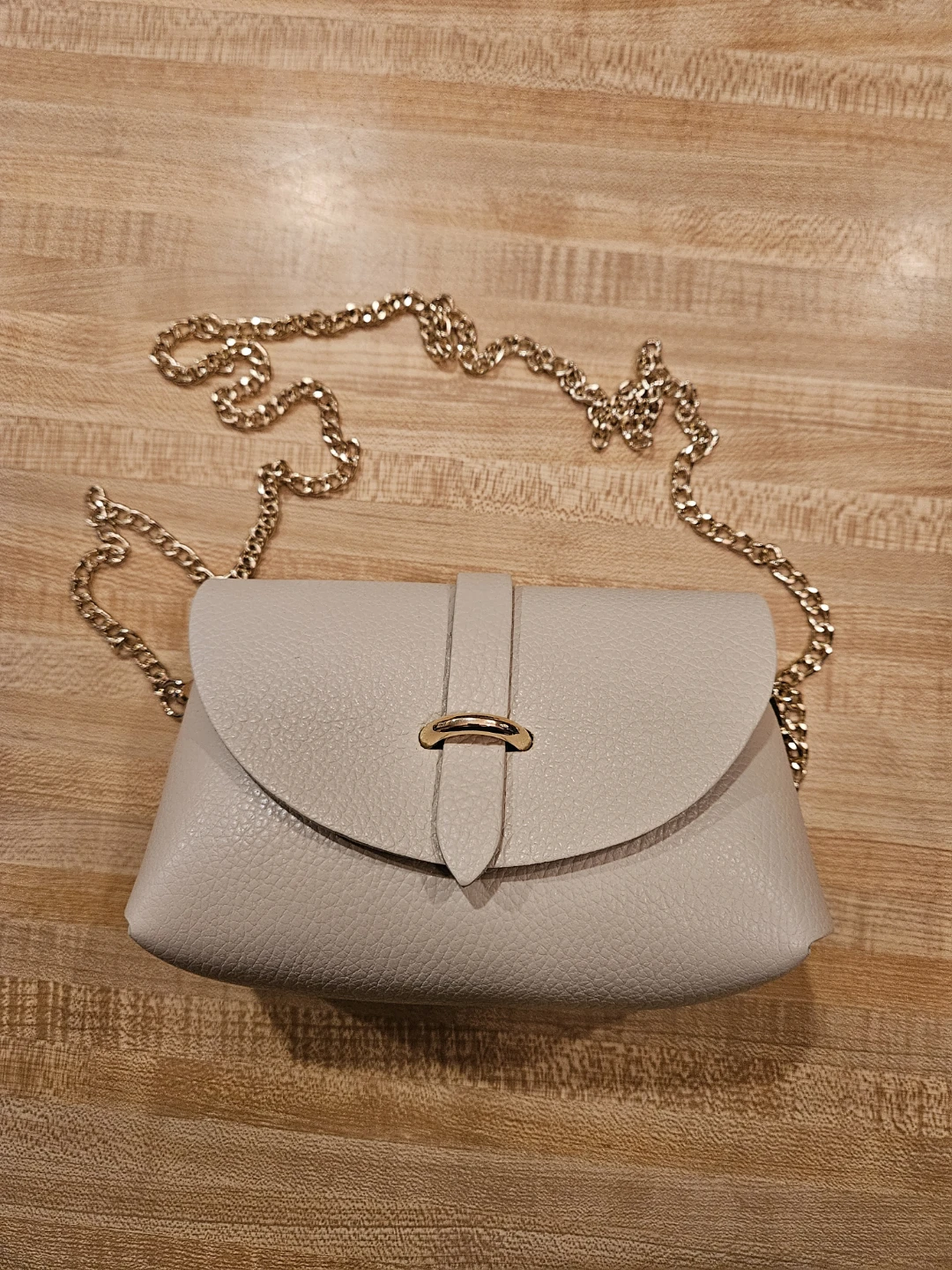 Small cream crossbody bag with gold chain strap