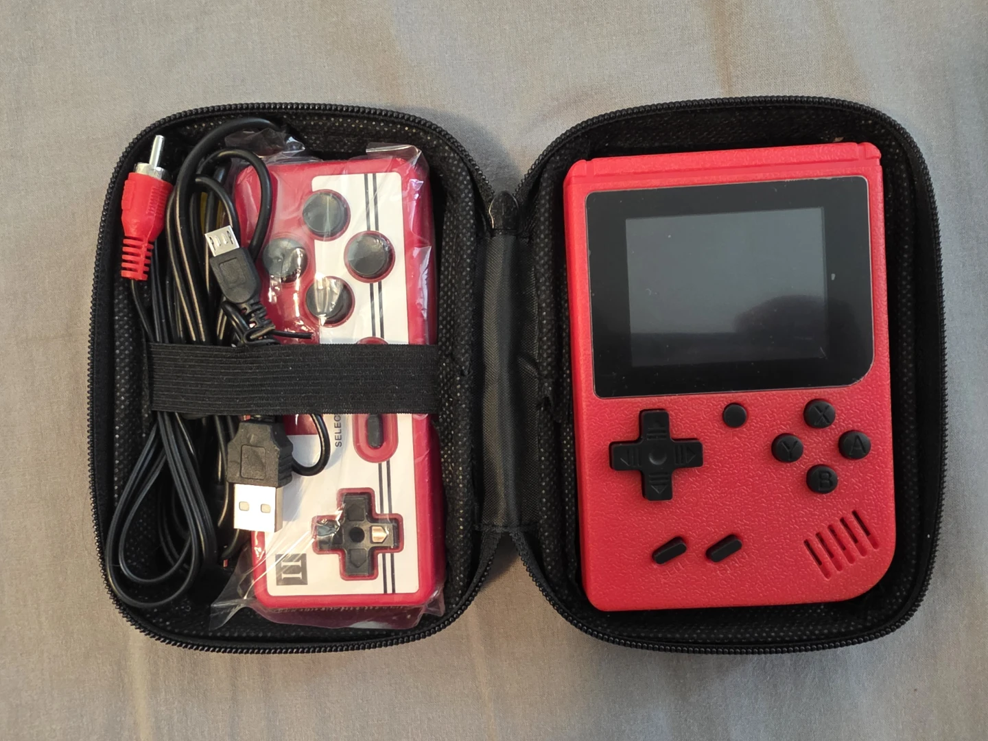 Red Handheld Retro Game Console with Controller and Cables