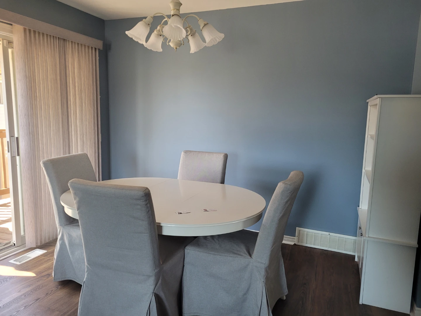 White Oval Dining Table with 4 Grey Slipcovered Chairs